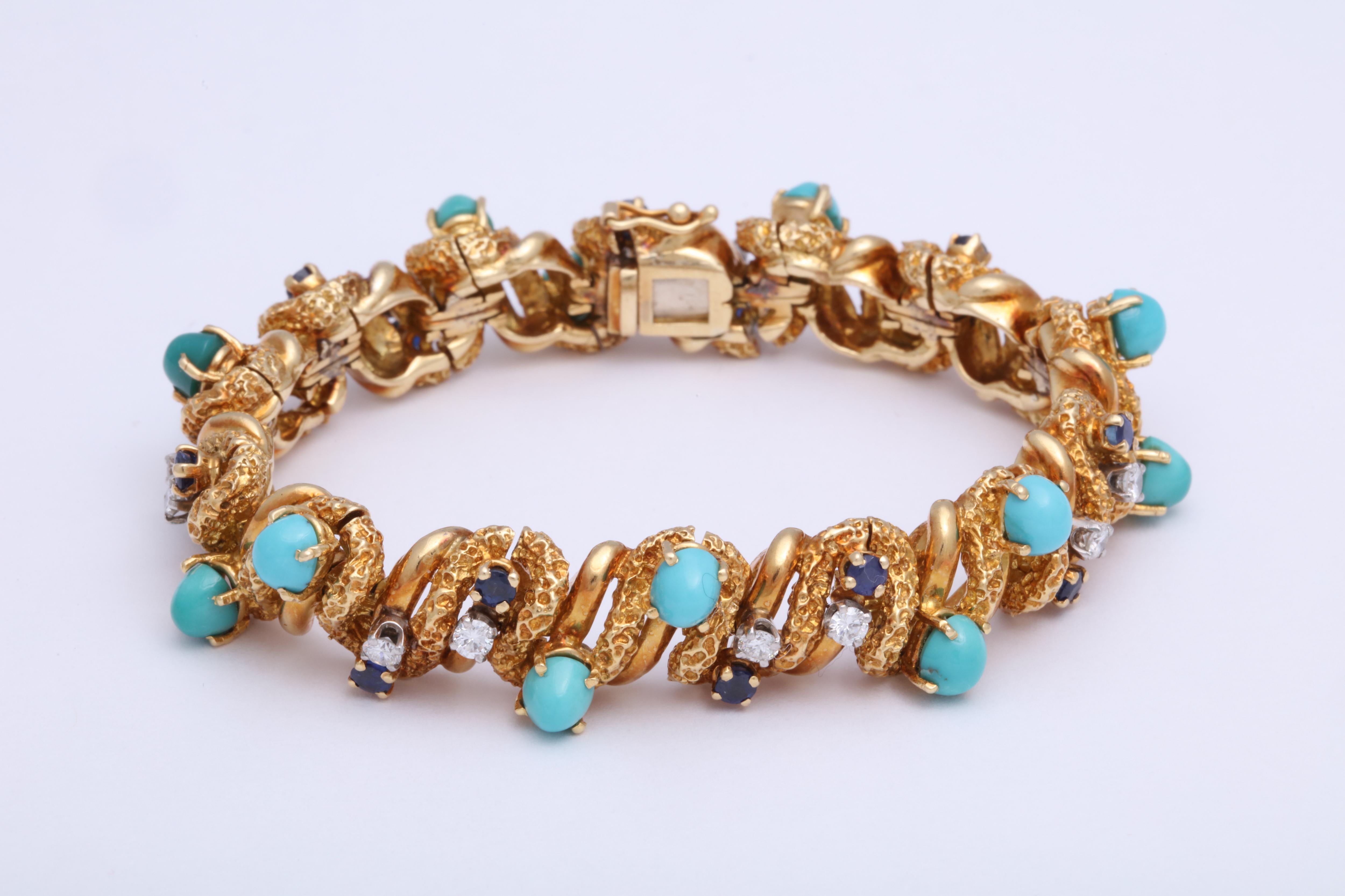 Chased and Polished 18kt Yellow Gold Bracelet set with 14 full cut Diamonds, 14 cabochon Turquoise  and 14 faceted  Sapphires - all prong set and making a medley of alternating colors.  
So -1950's - leaping into the 60's and inching  from prim and