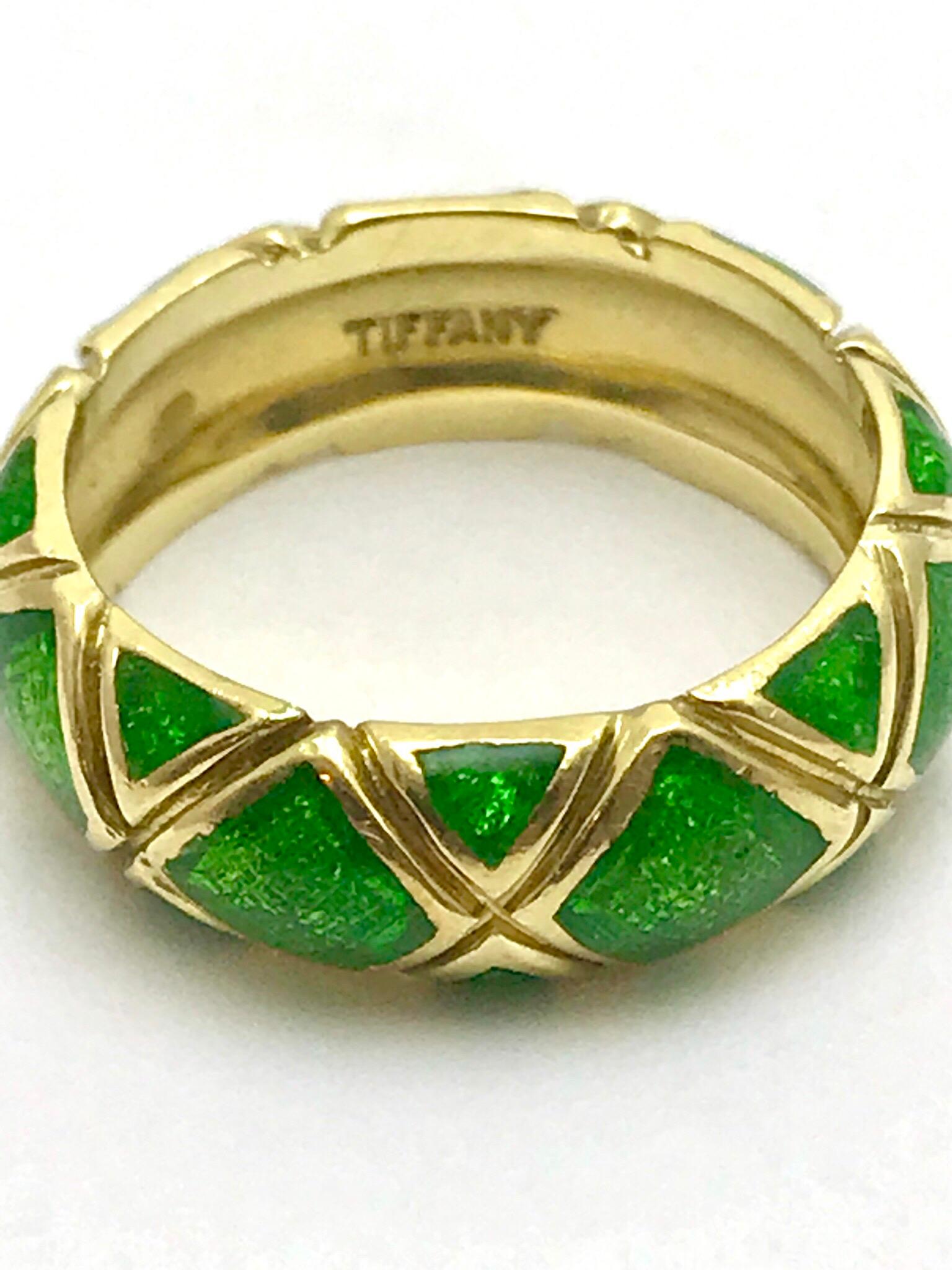 A Tiffany & Co. green enamel and 18 karat yellow gold band.  The band is designed with an 