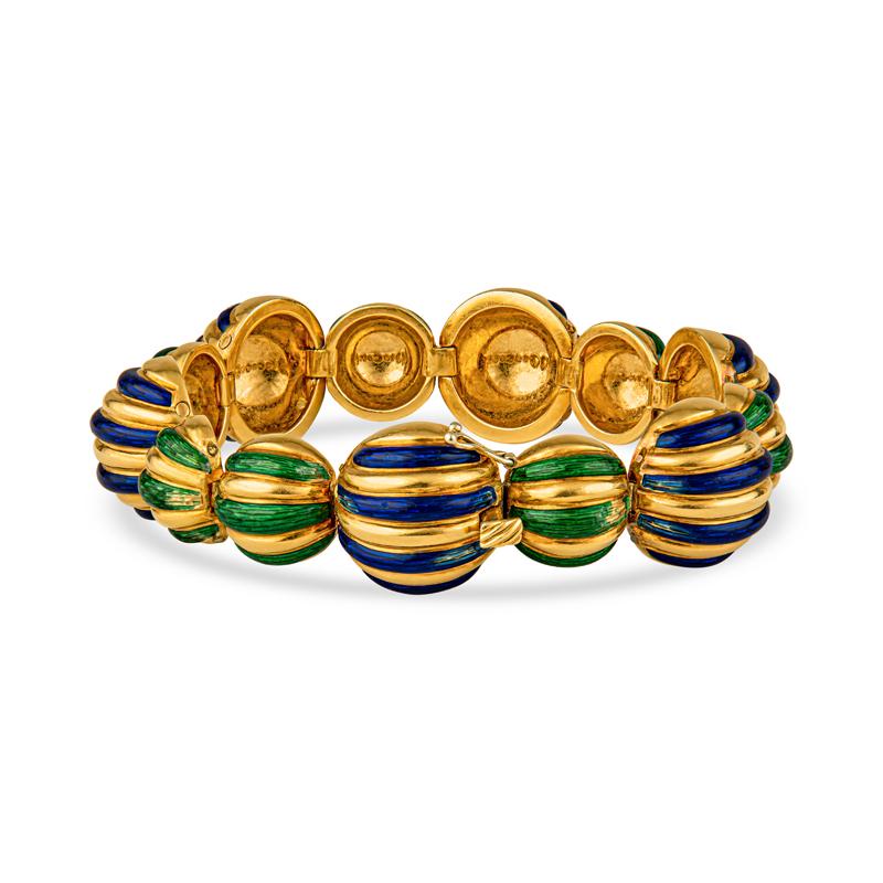 This vintage bracelet from Tiffany & Co. features vibrant green and purple enamel on carved 18 karat yellow gold links. Box with safety clasp. This bracelet can be worn everyday or saved for special occasions. Made in Italy. Bracelet circa