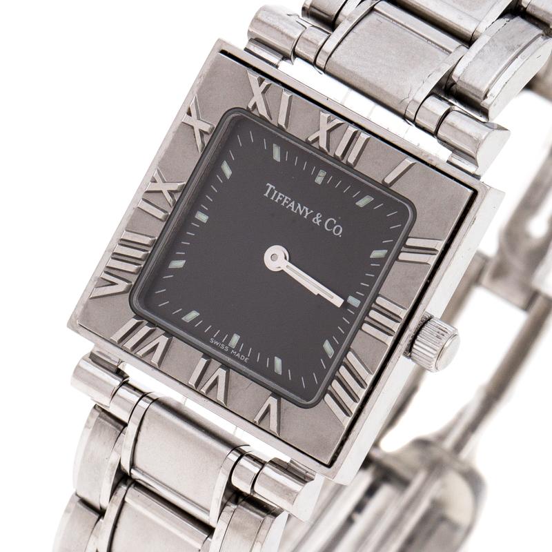 This Tiffany & Co. Atlas Wristwatch is charismatic and captivating. It comes in a square case with the bezel engraved with Roman numerals for hours, a signature element of the Atlas collection. The dial in grey houses silver-tone indicators and the