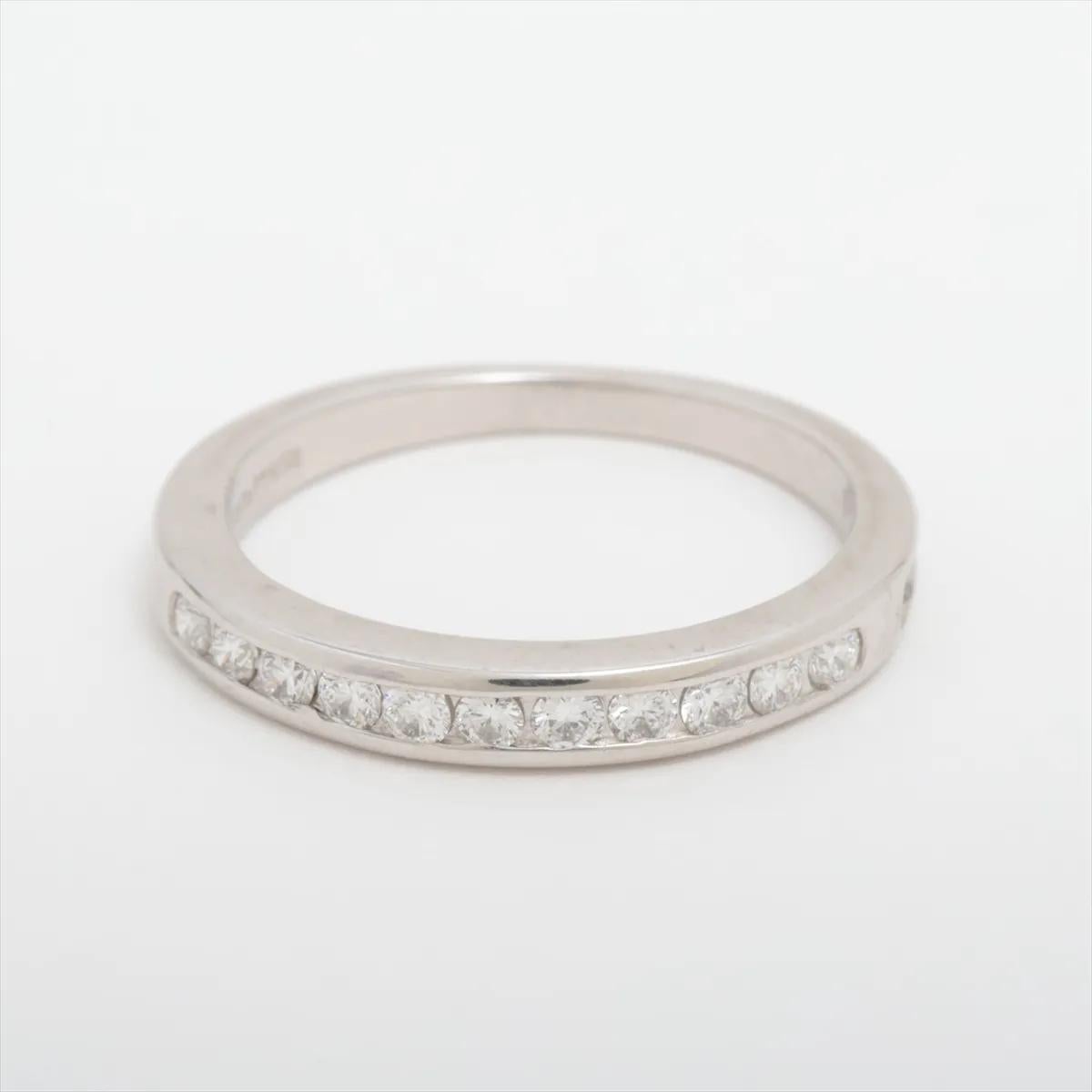 The Tiffany & Co. Half Circle Channel Setting Diamond Ring in Platinum showcases a perfect balance of timeless elegance and refined craftsmanship. Meticulously crafted from premium platinum, the ring features a half circle of dazzling round