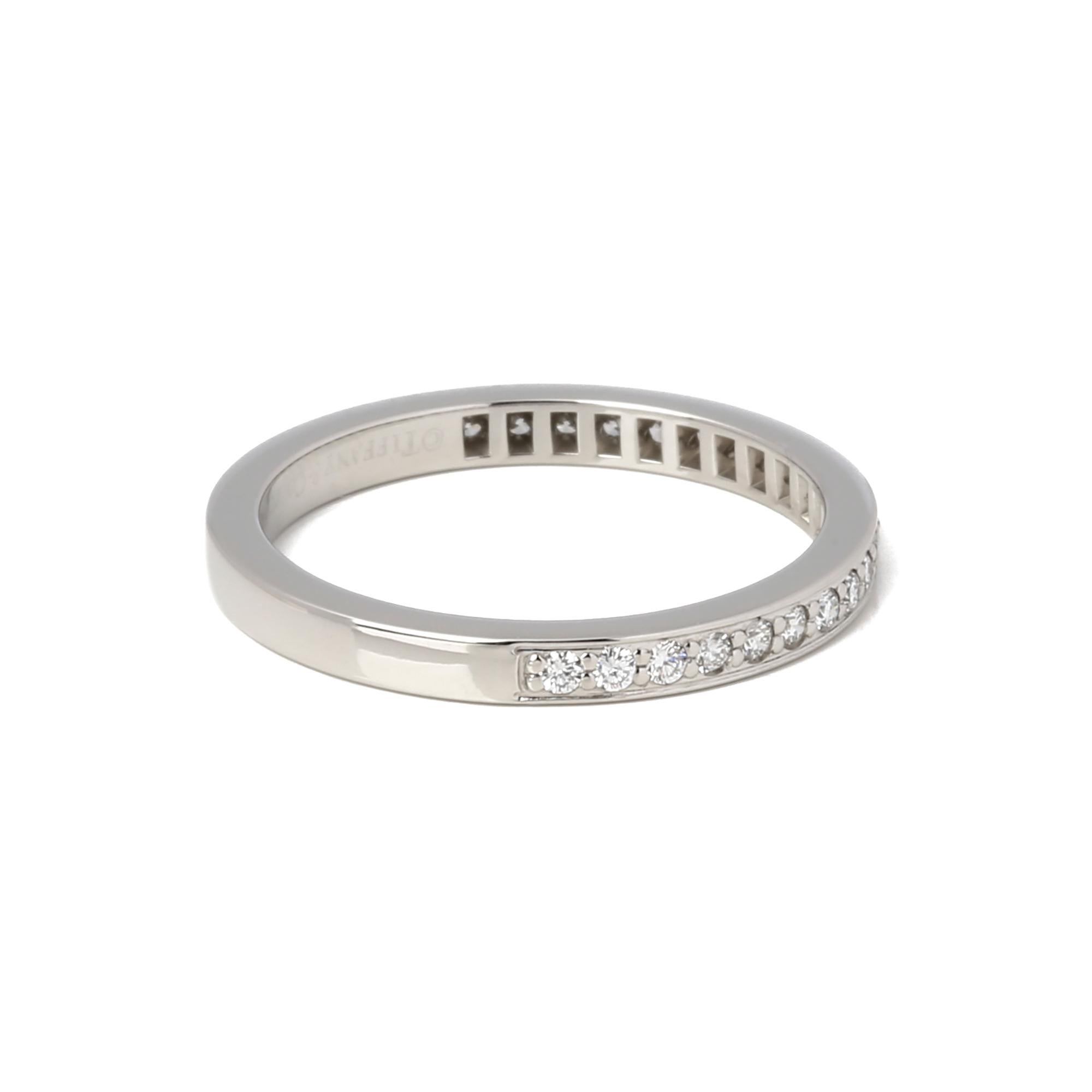 This half diamond ring by Tiffany & Co features 28 diamonds and is mounted in Platinum. UK ring size M. EU ring size 52. US ring size 6 1/2. Accompanied by a Xupes presentation box. Our Xupes reference is J718 should you need to quote this. 