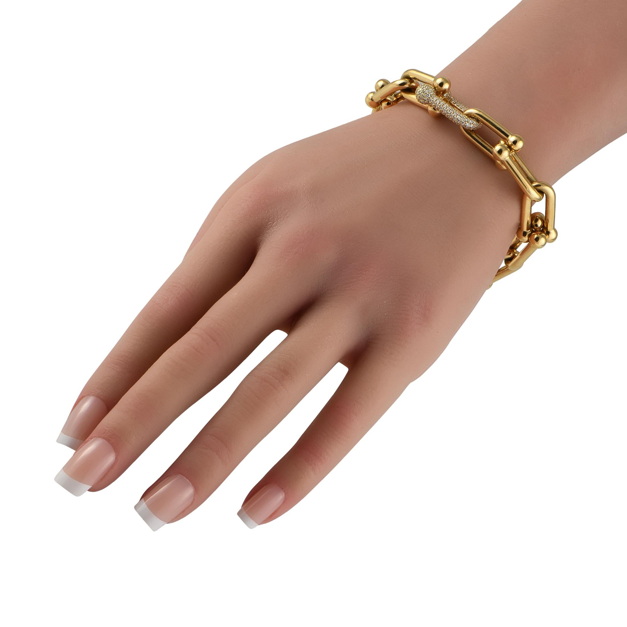 This Tiffany & Co. Hardware bracelet is a chic, contemporary piece that is currently trending. Bold 18K Yellow Gold links add texture to this 8 long bracelet. A single link covered in Diamonds totaling 1.70 carats serves as a stunning focal