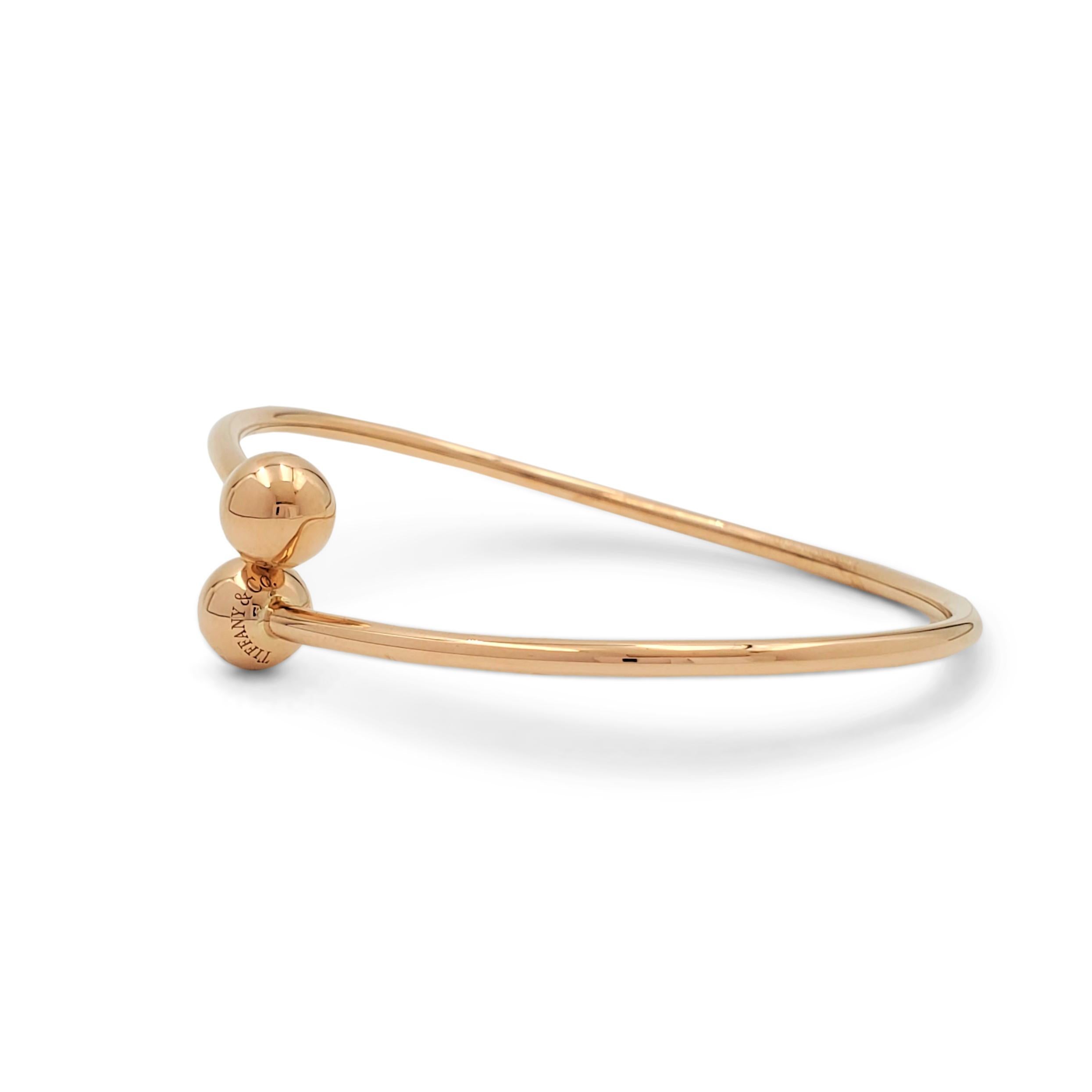 Simple and timeless Tiffany & Co. 'HardWear Ball Bypass' bracelet crafted in solid 18 karat rose gold. Signed Tiffany & Co., AU750 ITALY on the base of the bangle and 'NEW YORK' on the ball ends. The bracelet is not presented with the original box