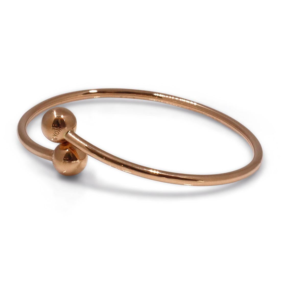 Authentic Tiffany & Co. 'HardWear Ball Bypass' bangle bracelet crafted in 18 karat rose gold. Will fit up to 6 1/2 inch wrist. Signed Tiffany & Co., Au750, ITALY on the base of the bangle and 'TIFFANY & CO', 'NEW YORK' on the ball ends. The bracelet