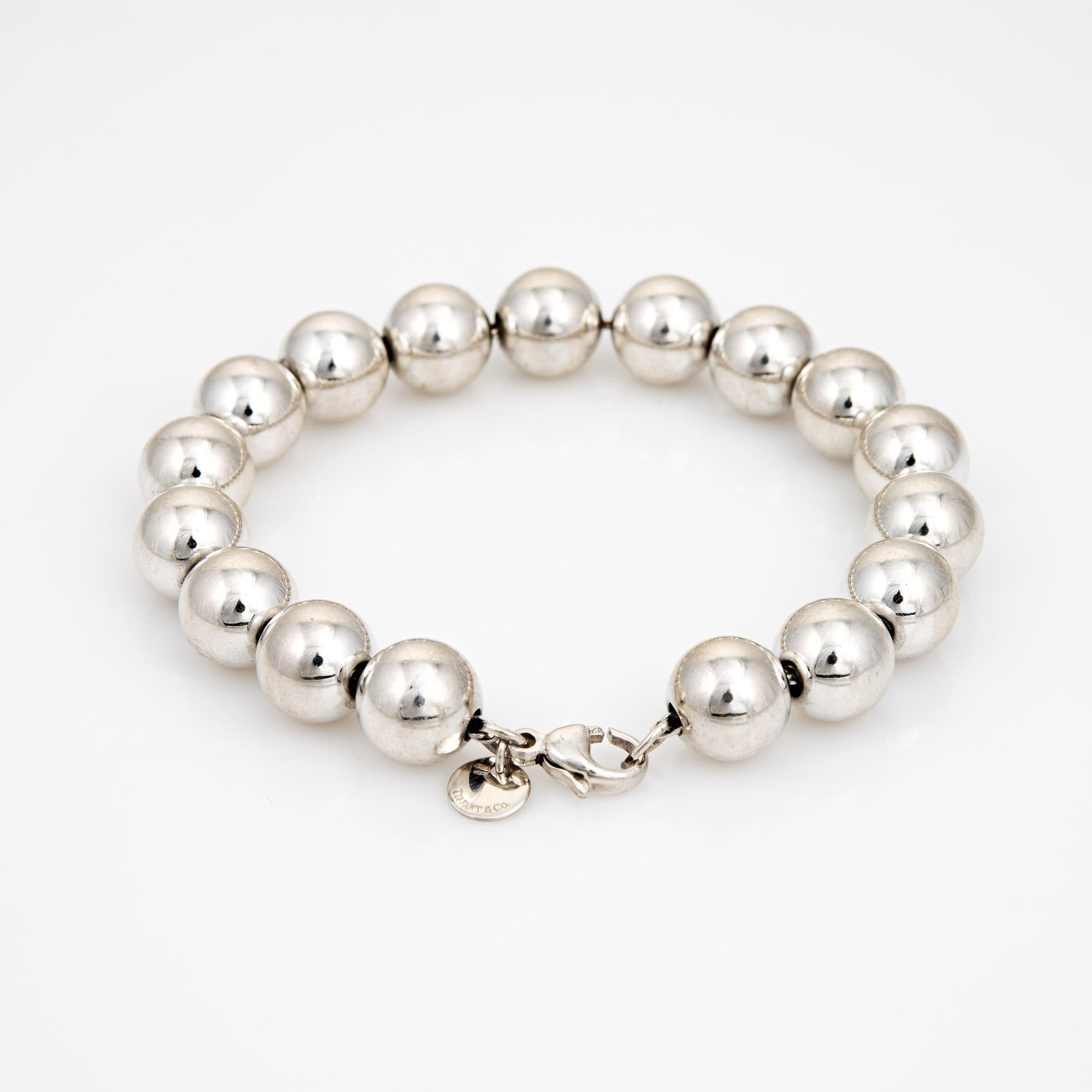 Stylish pre-owned Tiffany & Co graduated silver bead bracelet crafted in 925 sterling silver.  

The bracelet features silver beads that are uniform in size (10mm). Great worn alone or layered with your fine jewelry from any era.

The bracelet is in