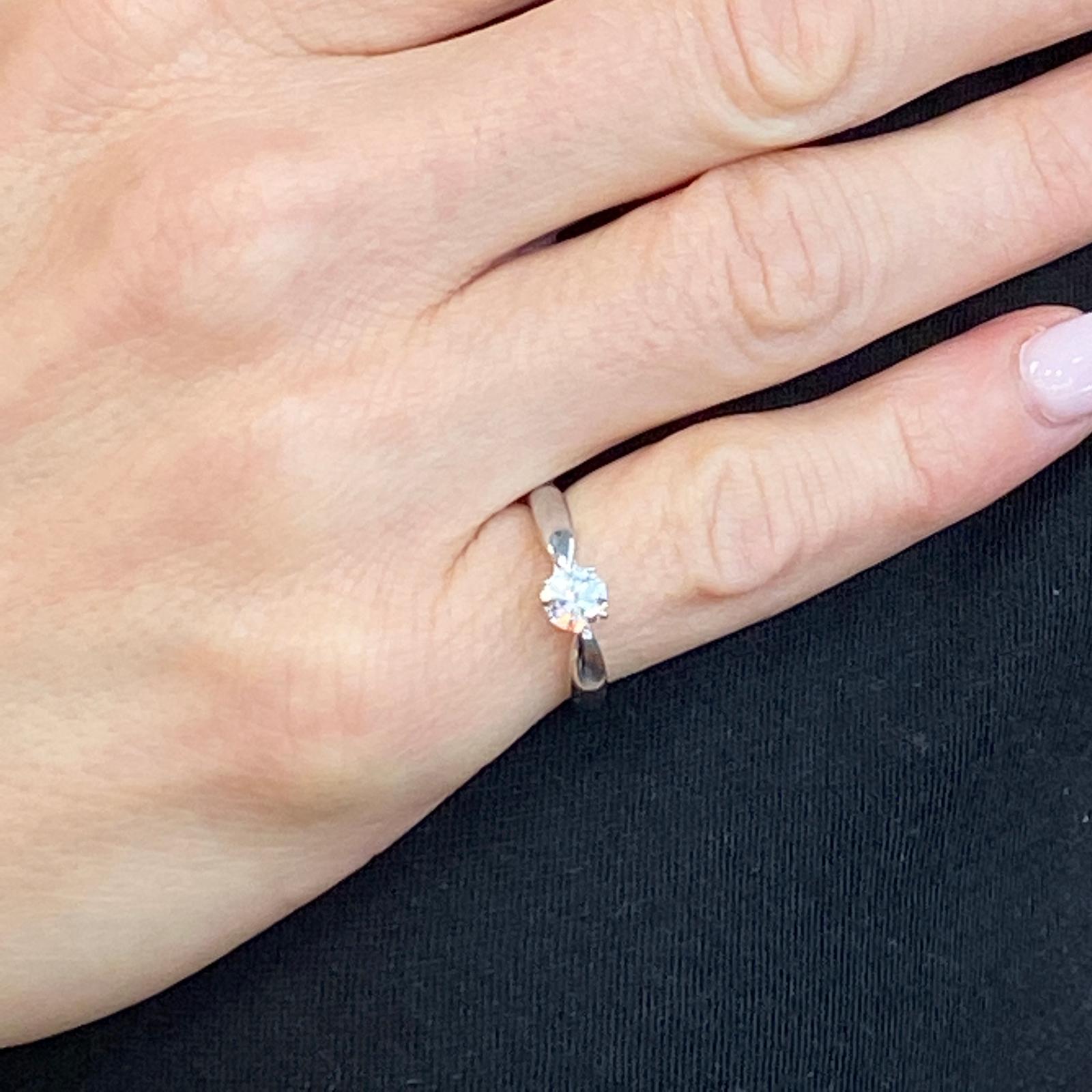 Tiffany & Co. Harmony diamond solitaire engagement ring fashioned in platinum. The round brilliant cut diamond weighs .38 carats and is graded H color and VVS clarity. The ring is signed Tiffany & Co. PT 950, numbered and is marked 0.38 CT.