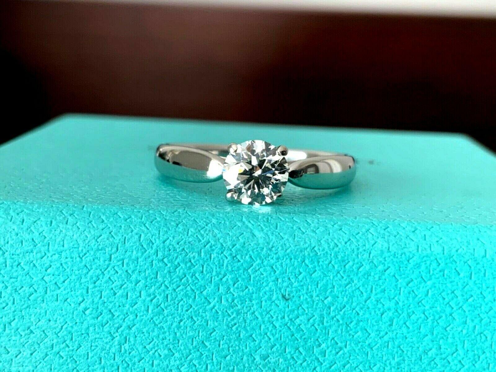 JUST IN TODAY!  

You are viewing one of the HOTTEST Tiffany & Co Round solitaires sold at Tiffany's and one of the HARDEST PRE-OWNED rings to find.  Do your research and you will be lucky to find another for sale preowned Tiffany Harmony with all