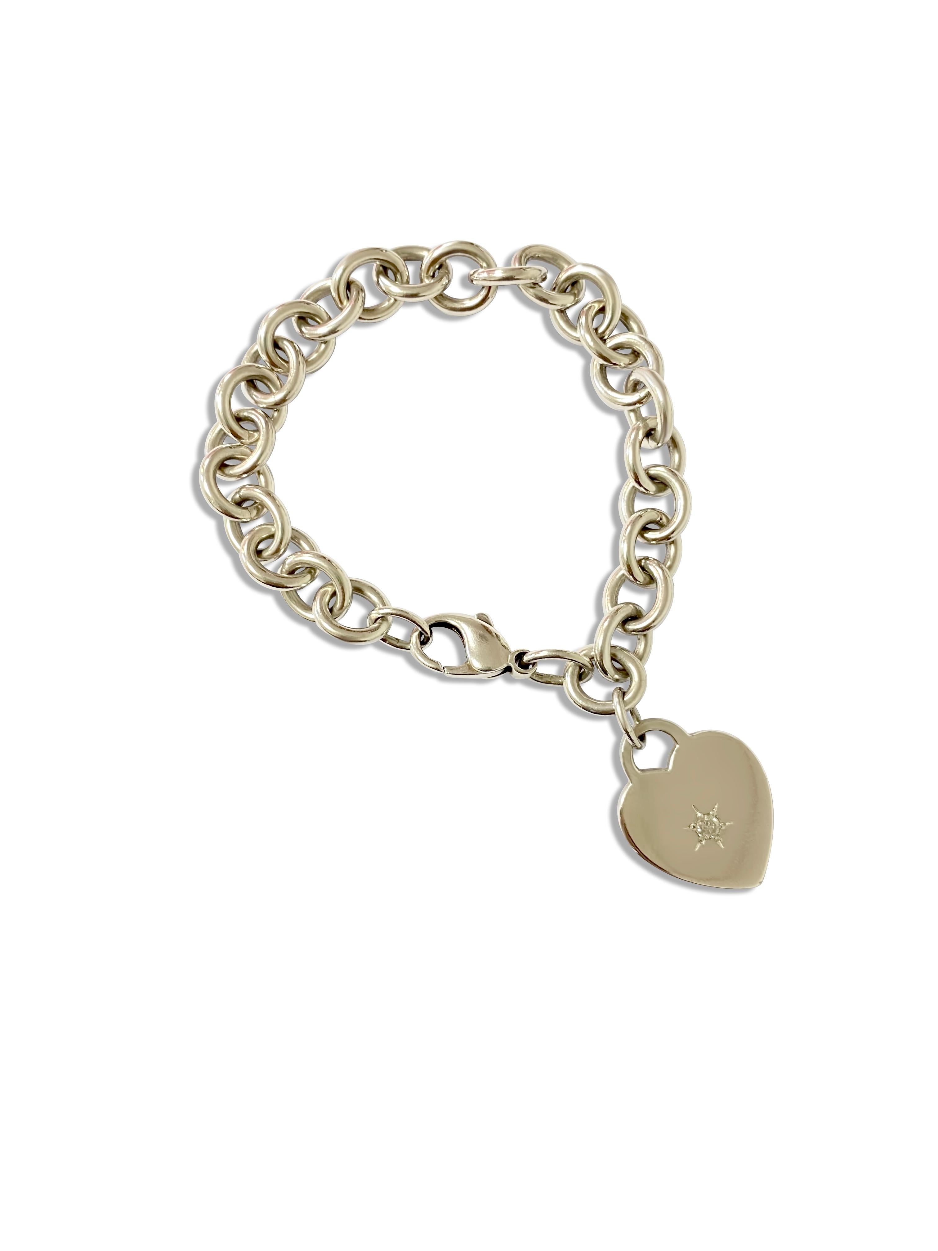 Brand: Tiffany & Co.
Metal: Sterling silver
Diamond: single round brilliant cut stone. 
Weight: 34.6 grams
Length: 7.50 inches

Beautiful heart charm Tiffany and co bracelet. In excellent condition. 

No box and no papers
