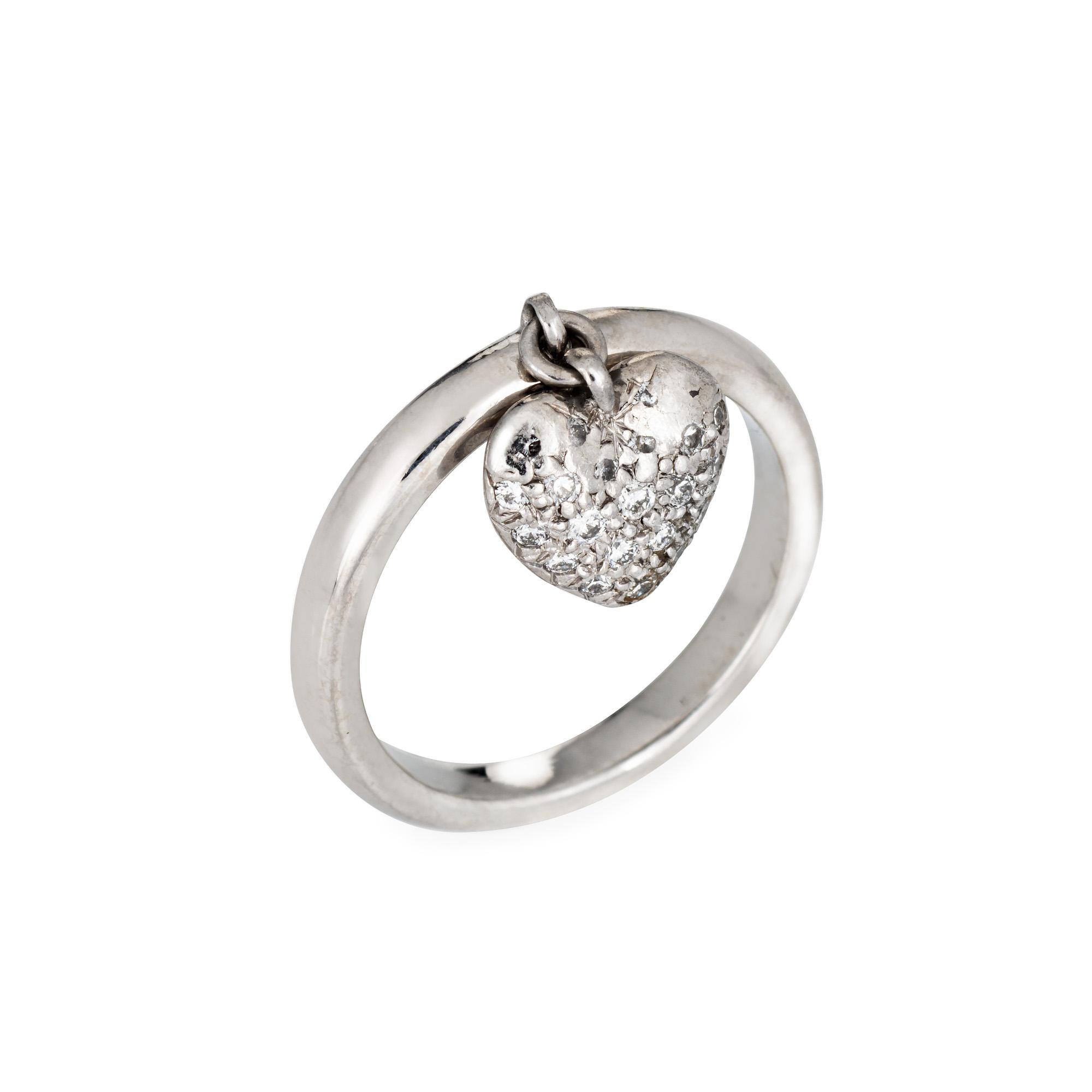 Finely detailed pre owned Tiffany & Co pave diamond heart charm ring crafted in platinum. 

Diamonds are pave set into the heart and total an estimated 0.15 carats (estimated at F-G color and VVS2 clarity). 

The stylish ring features a diamond set