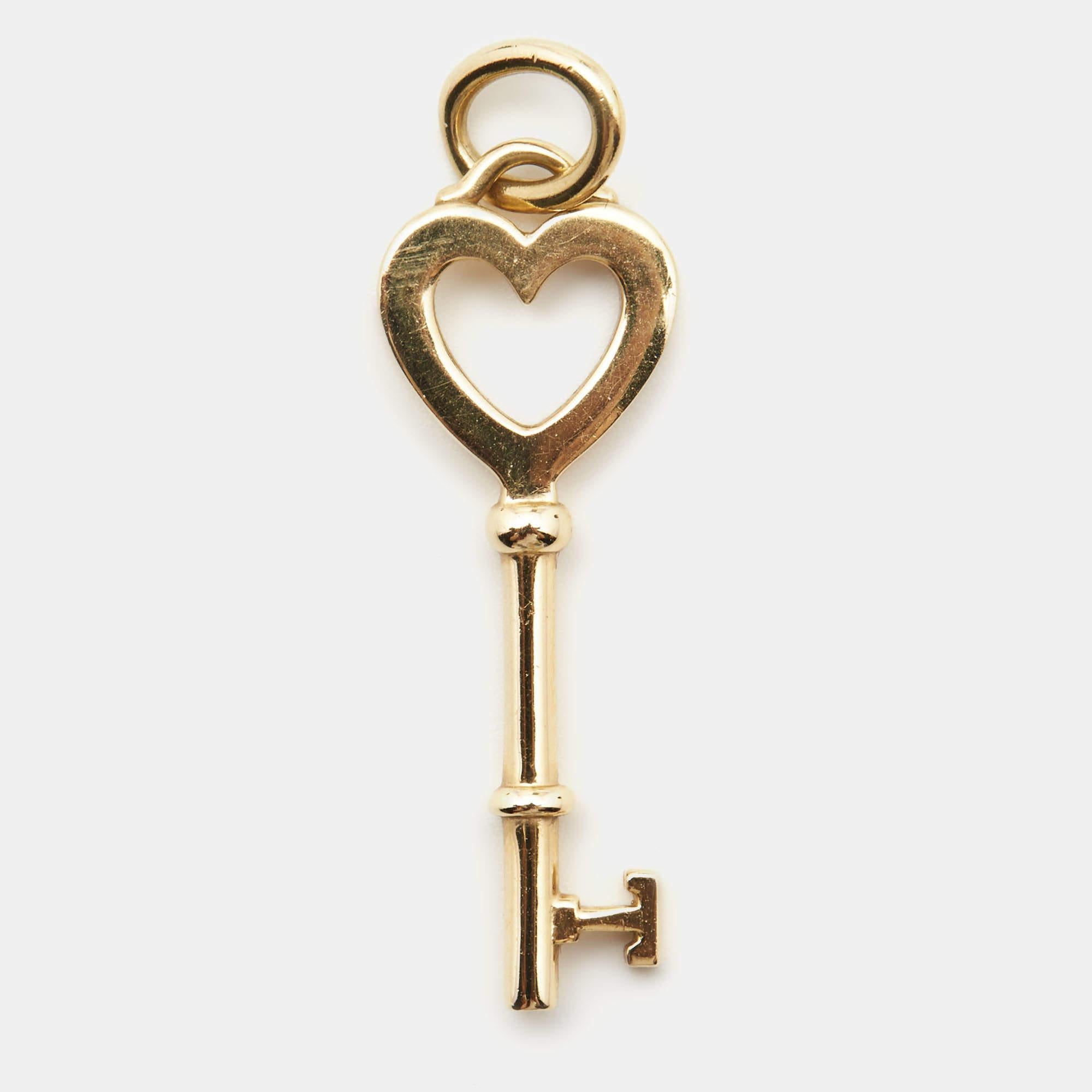 This Tiffany & Co. beauty comes made from 18k yellow gold into a pendant. The creation has a heart-shaped bow and a bail on top that allows you to use it with necklace or bracelet chains. The pendant, like all of the other keys from Tiffany,