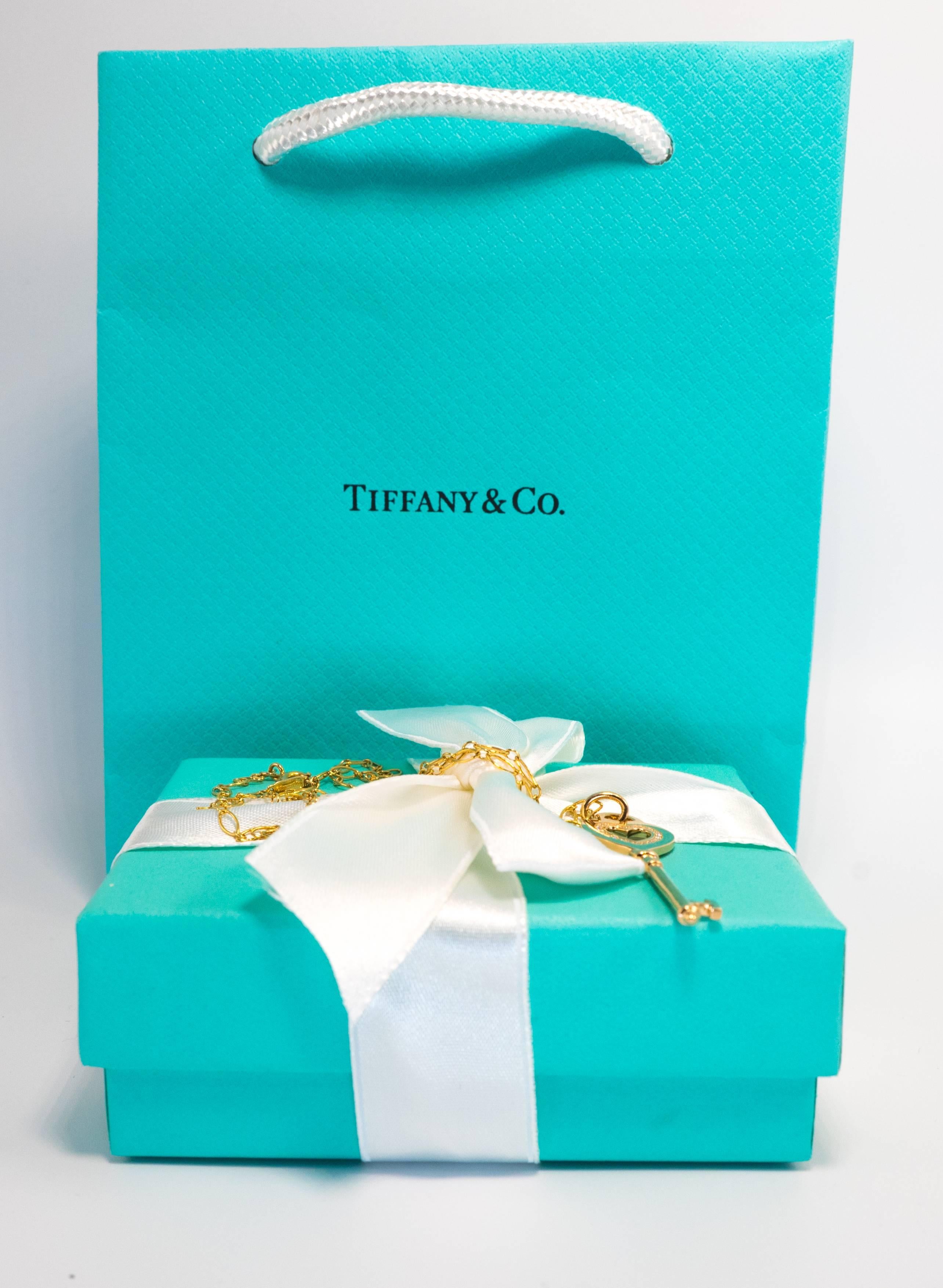 Round Cut Tiffany & Co. Heart Key Pendant with Diamonds and Chain in 18 Karat Yellow Gold