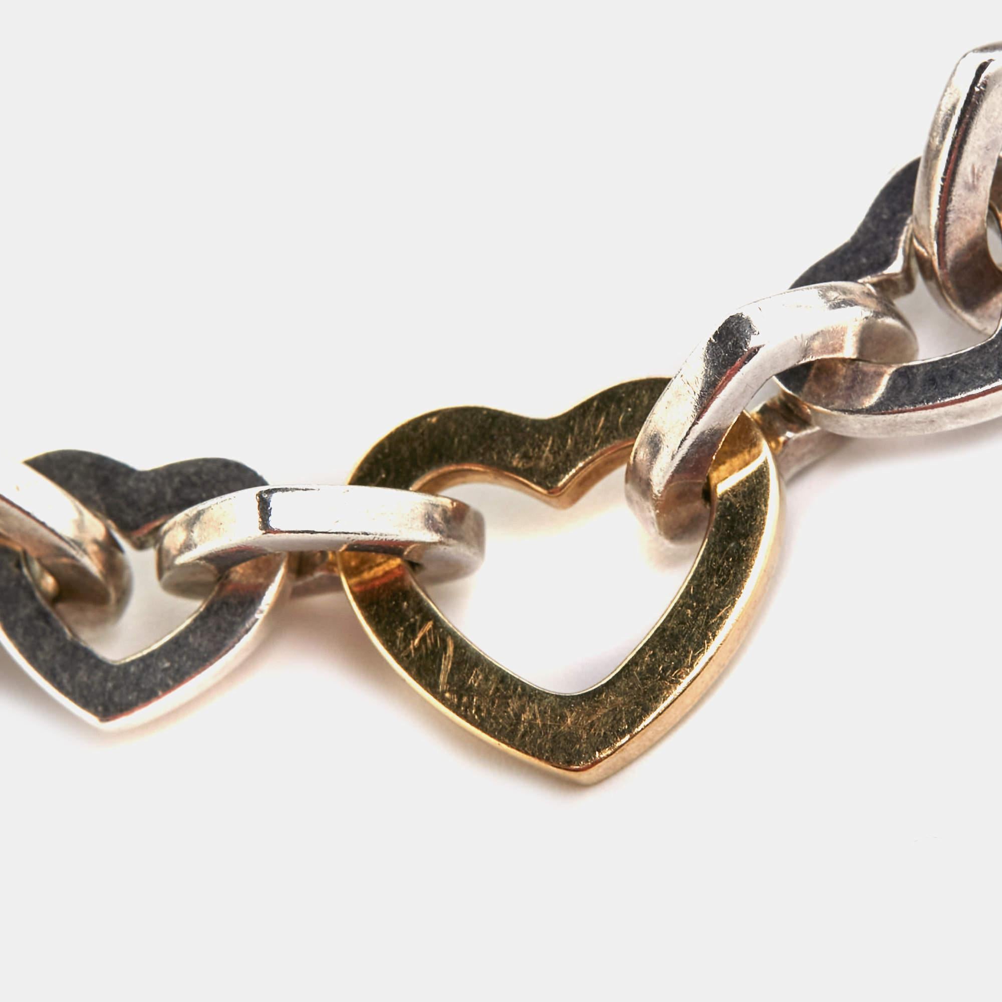 Presenting the exquisite Tiffany & Co. bracelet, a stunning blend of sterling silver and 18k yellow gold. This captivating piece exudes timeless charm with its heart design, symbolizing love and connection. Elevate your style effortlessly with this