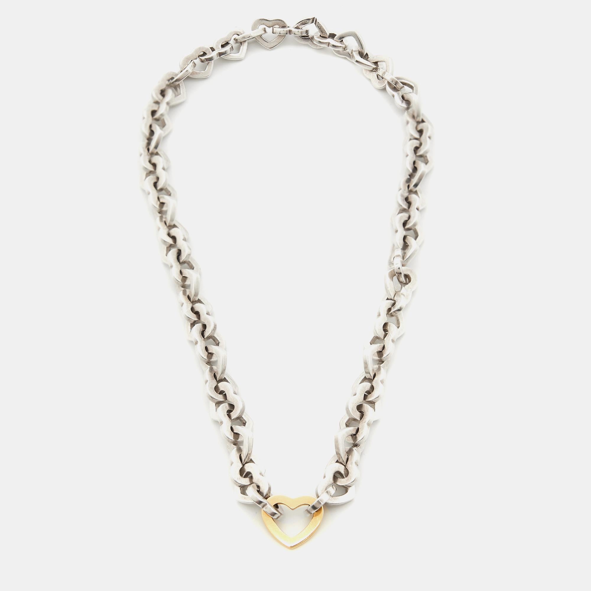 Presenting the exquisite Tiffany & Co. necklace, a stunning blend of sterling silver and 18k yellow gold. This captivating piece exudes timeless charm with its heart design, symbolizing love and connection. Elevate your style effortlessly with this