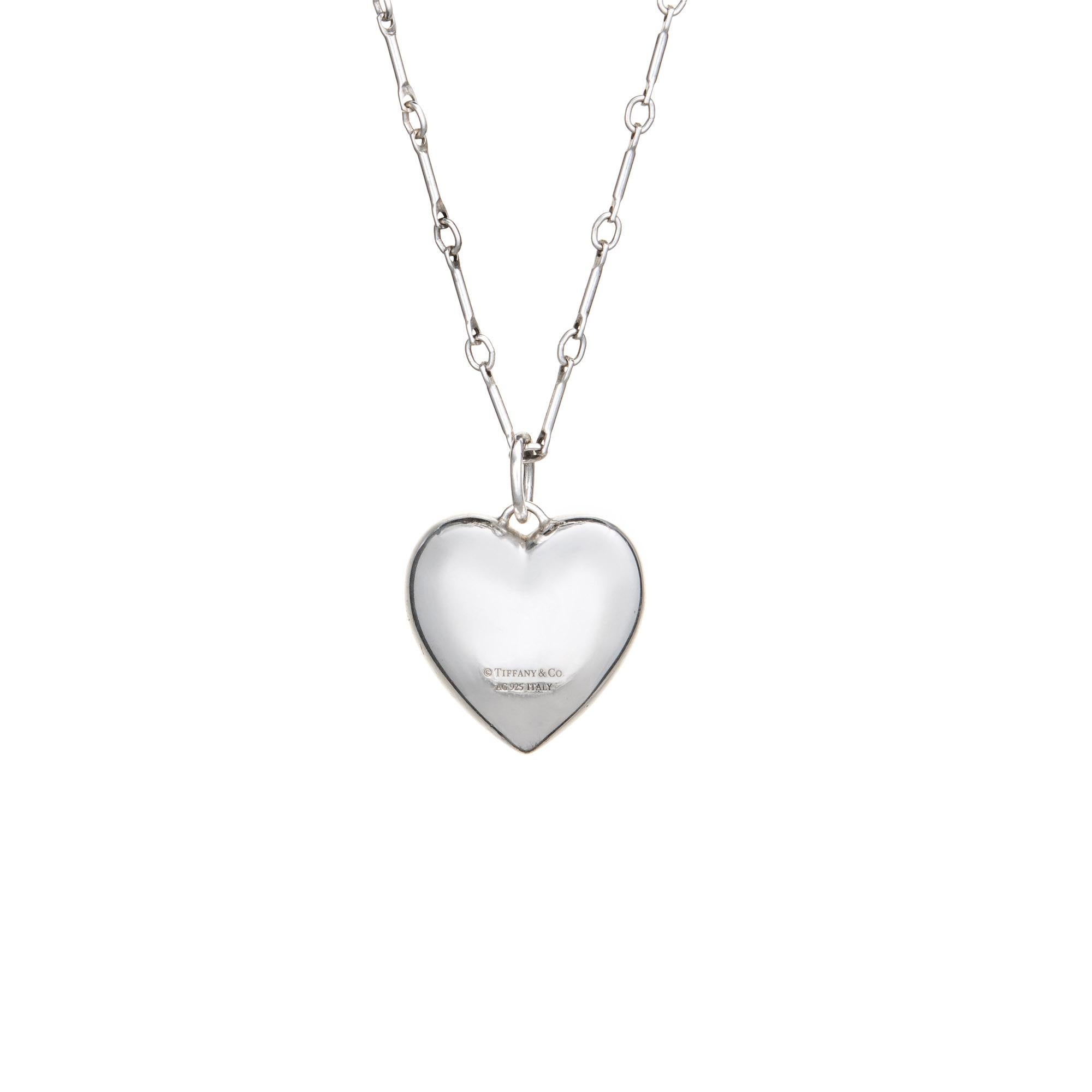 Elegant and finely detailed estate Tiffany & Co sterling silver heart necklace.  

The puffed heart is medium sized in scale, measuring 3/4 inches. Also included is the fine bar link Tiffany & Co chain measuring 18 inches in length. The necklace
