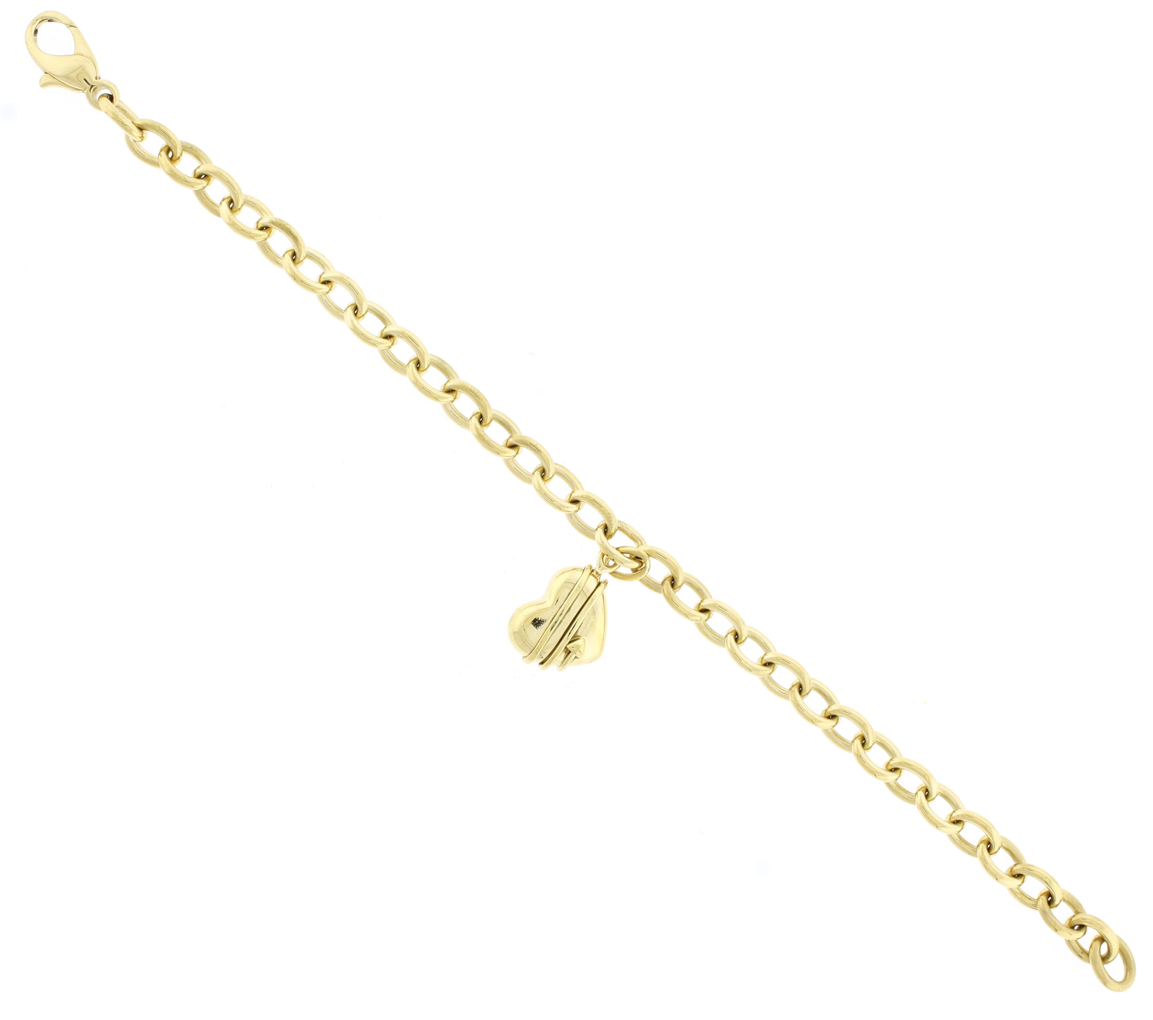 From Tiffany & Co, a gold  bracelet charm with a heart and cupid’s wrapped arrow wrapped.
• Designer: Tiffany & Co.
• Metal: 18 karat gold
• Circa: Late 20th Century
• Size: 7 ½ inches long
• 27.1 grams
• Packaging:  Tiffany pouch
• Condition: Very