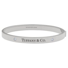 Tiffany & Co. Hinged Bangle bracelet in 18k White Gold with 2 Diamonds.