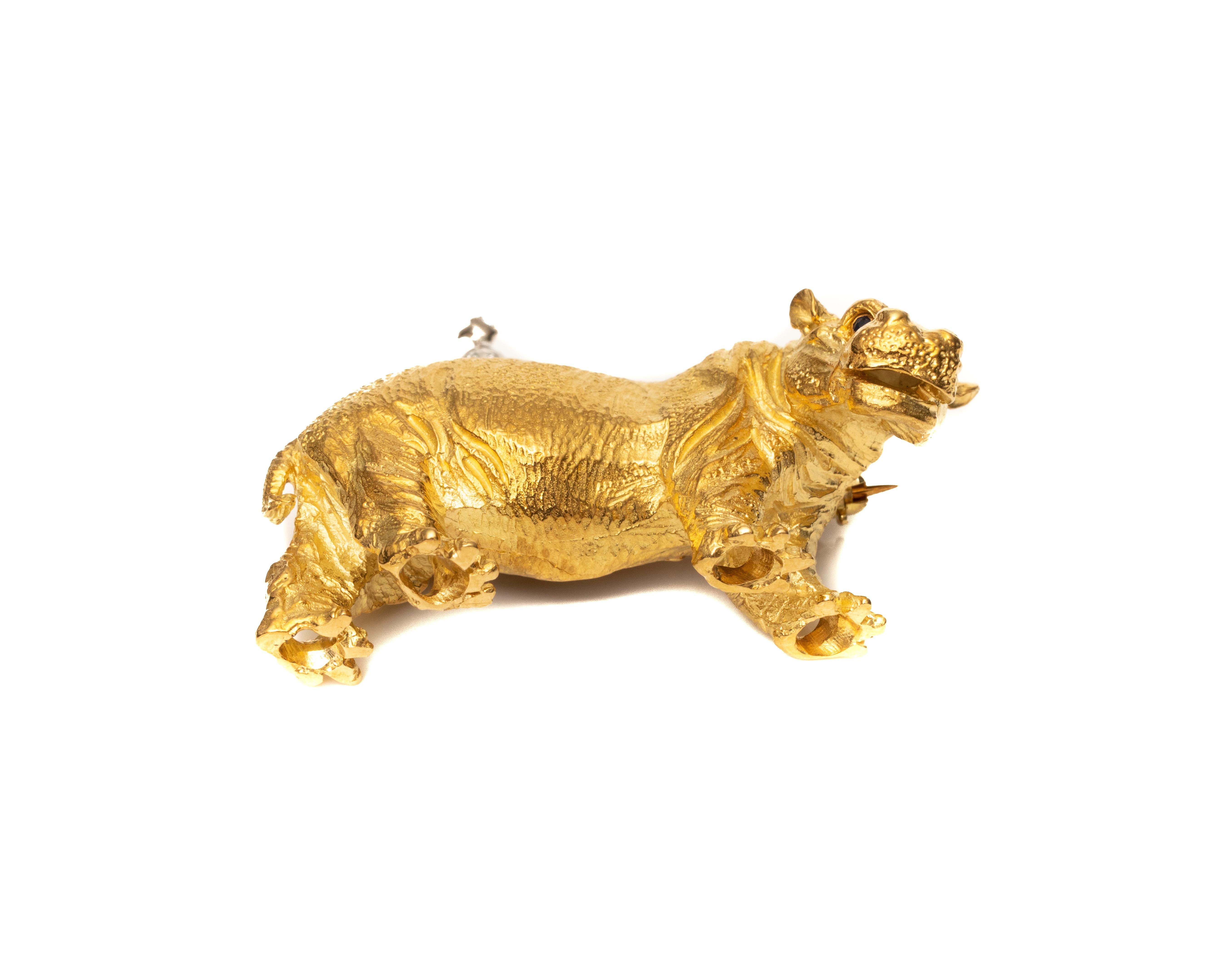Beautiful pin brooch from 1991, Tiffany & Co. made and crafted in Germany
It features a hippopotamus made of high contrast 18 karat yellow gold. There is an adorable bird made with accent diamonds, perched on top of the hippopotamus's back. It is a