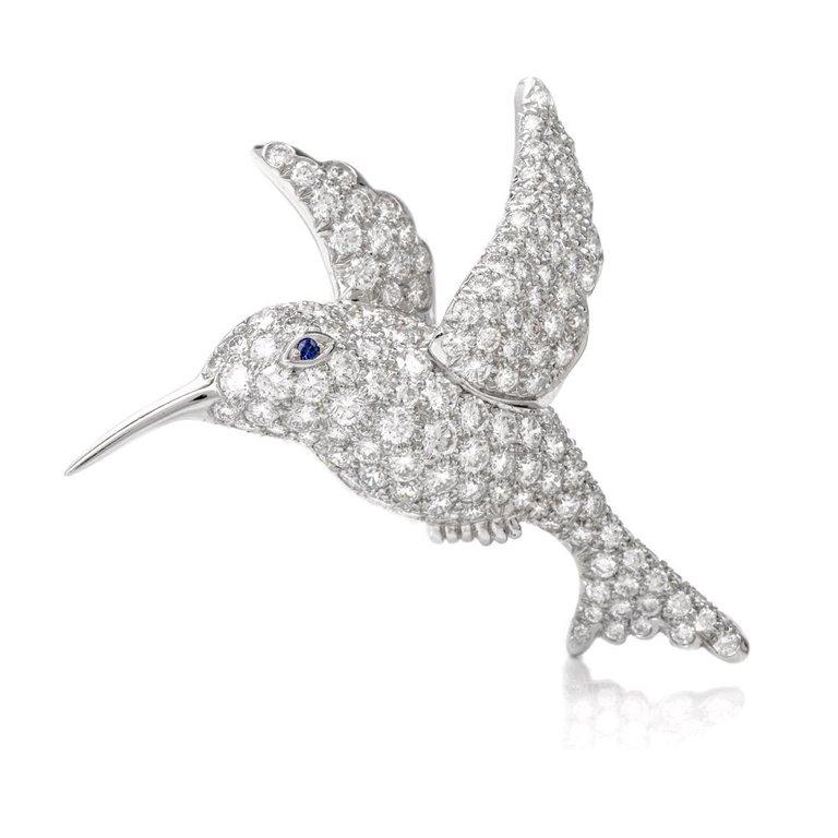 This Tiffany & Co. brooch pin is crafted in solid platinum, weighs 12.7 grams and measures 1.6 inches x 1.5 inches. Depicting a fanciful sculptured profile of a hummingbird, the delicate pin brooch is pave-set with 5.00 carats of high quality