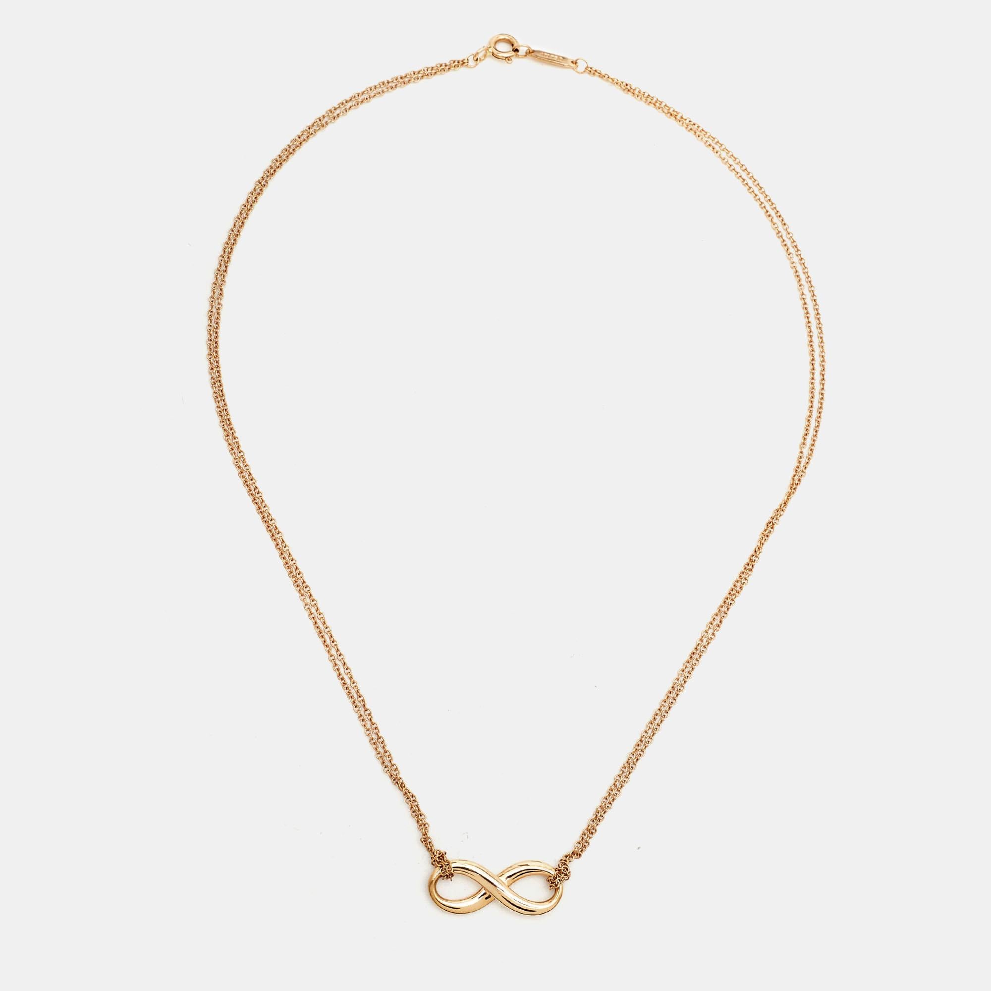 Crafted with elegance, the Tiffany & Co. Infinity necklace in 18k rose gold embodies timeless allure. Its delicate chain supports a captivating infinity symbol, a testament to endless love and boundless possibilities. Graceful and refined, this