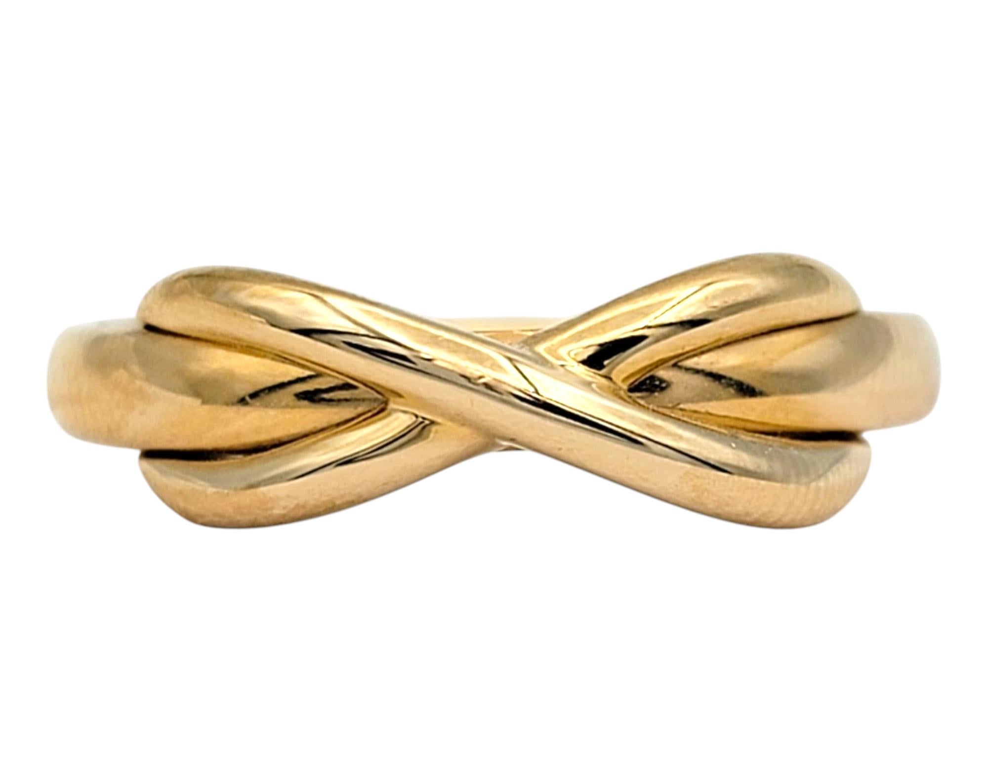 Ring Size: 6.75 

Timeless elegance meets symbolic design in this authentic Tiffany & Co. Infinity band, crafted in the warm glow of 18 karat rose gold. The sleek and polished infinity motif represents endless love and connection, making this piece