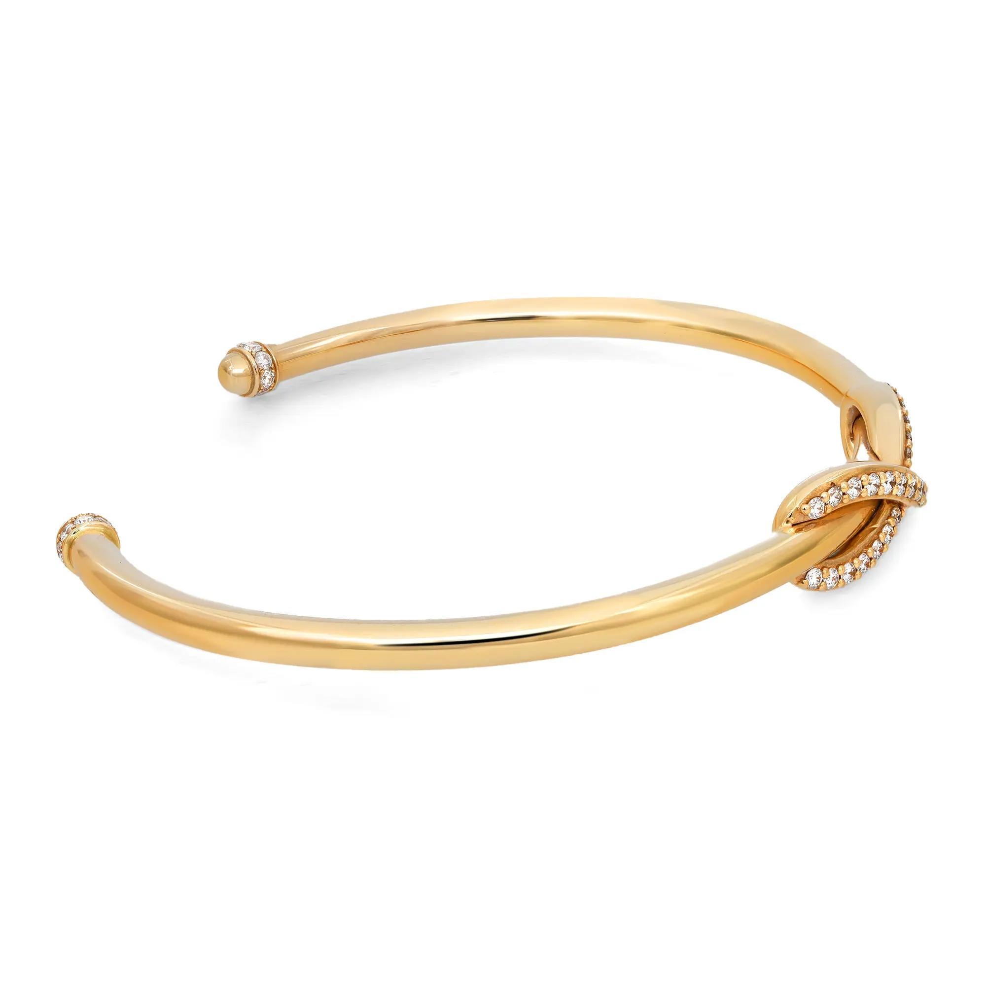 Gorgeous and elegant, Tiffiany & Co. Infinity Diamond Cuff Bracelet exudes sophistication. Stunningly crafted in lustrous 18K yellow gold. It features a cuff style bangle bracelet with a center infinity design studded with round brilliant cut