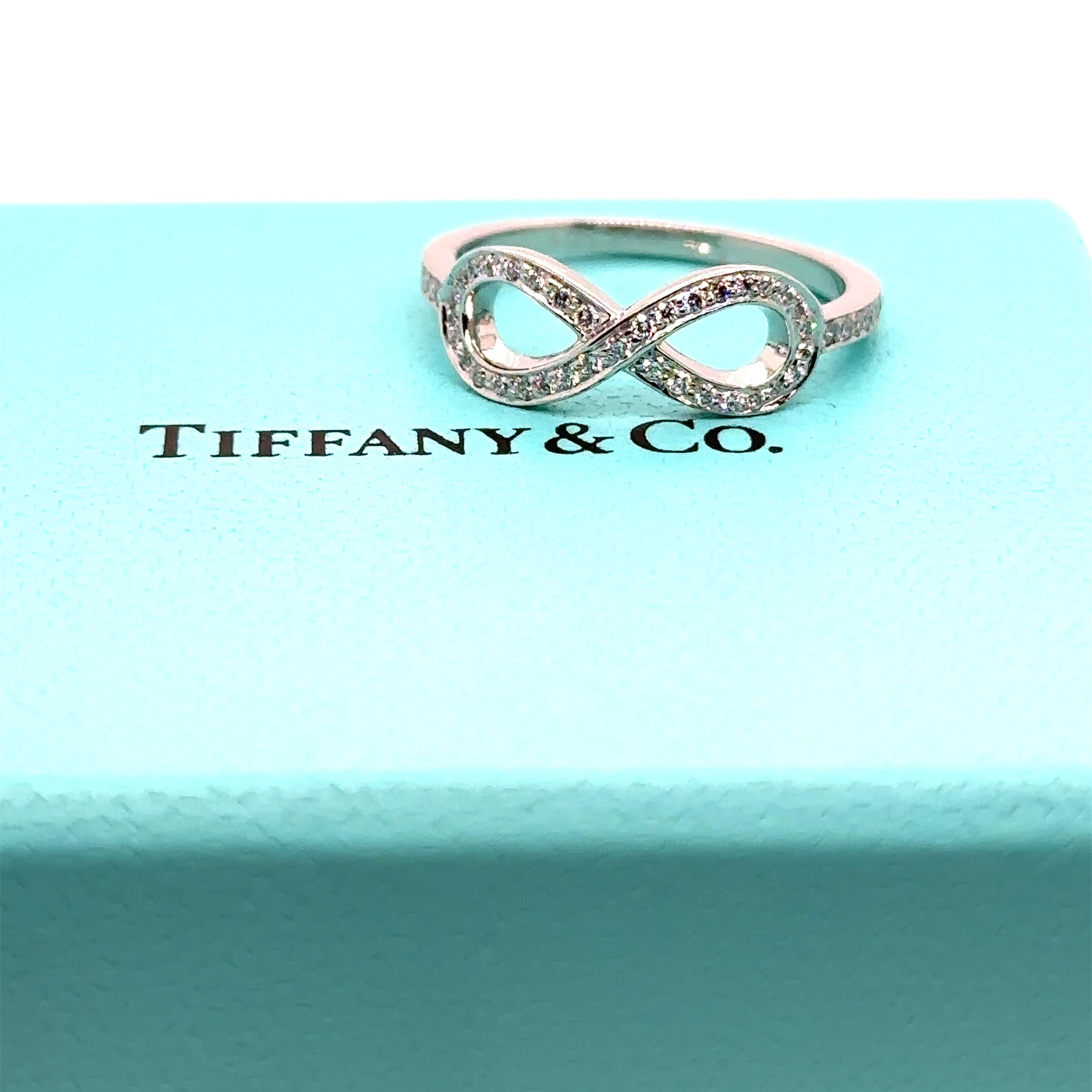 Unique features:

Tiffany and Co. Infinity Diamond ring. Made of 950 Platinum, and weighing 3.5 gm. Stamped: Tiffany and Co. PT 950.

Set with 47 round, brilliant cut Diamonds, colour F and clarity VS-SI. with a total weight of 0.25ct.
Metal: 950