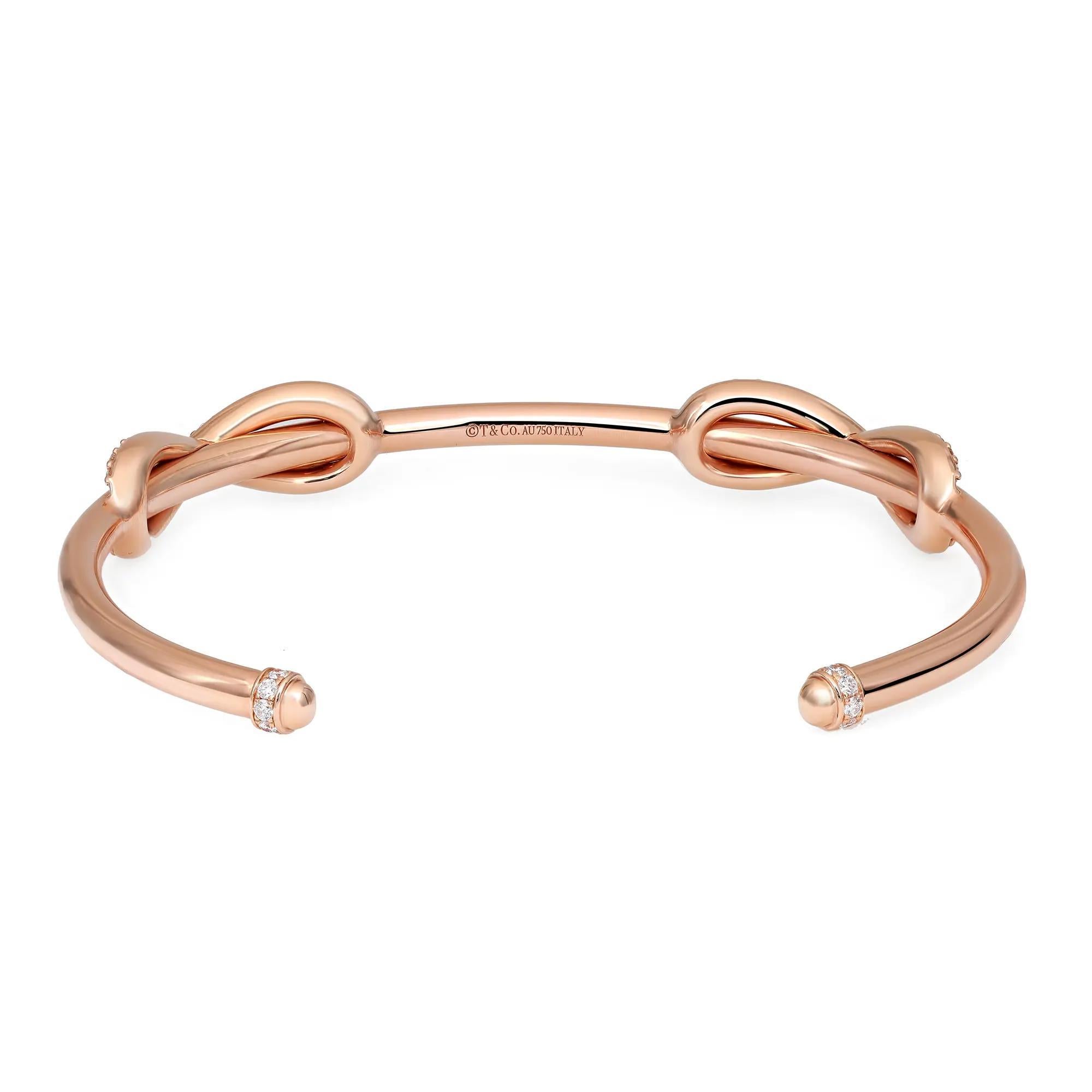 This gorgeous Tiffany & Co. cuff bracelet is crafted in solid 18K rose gold. It features a double infinity design encrusted with bright white round brilliant cut diamonds with exceptional brilliance. This bracelet has a wonderful highly polished