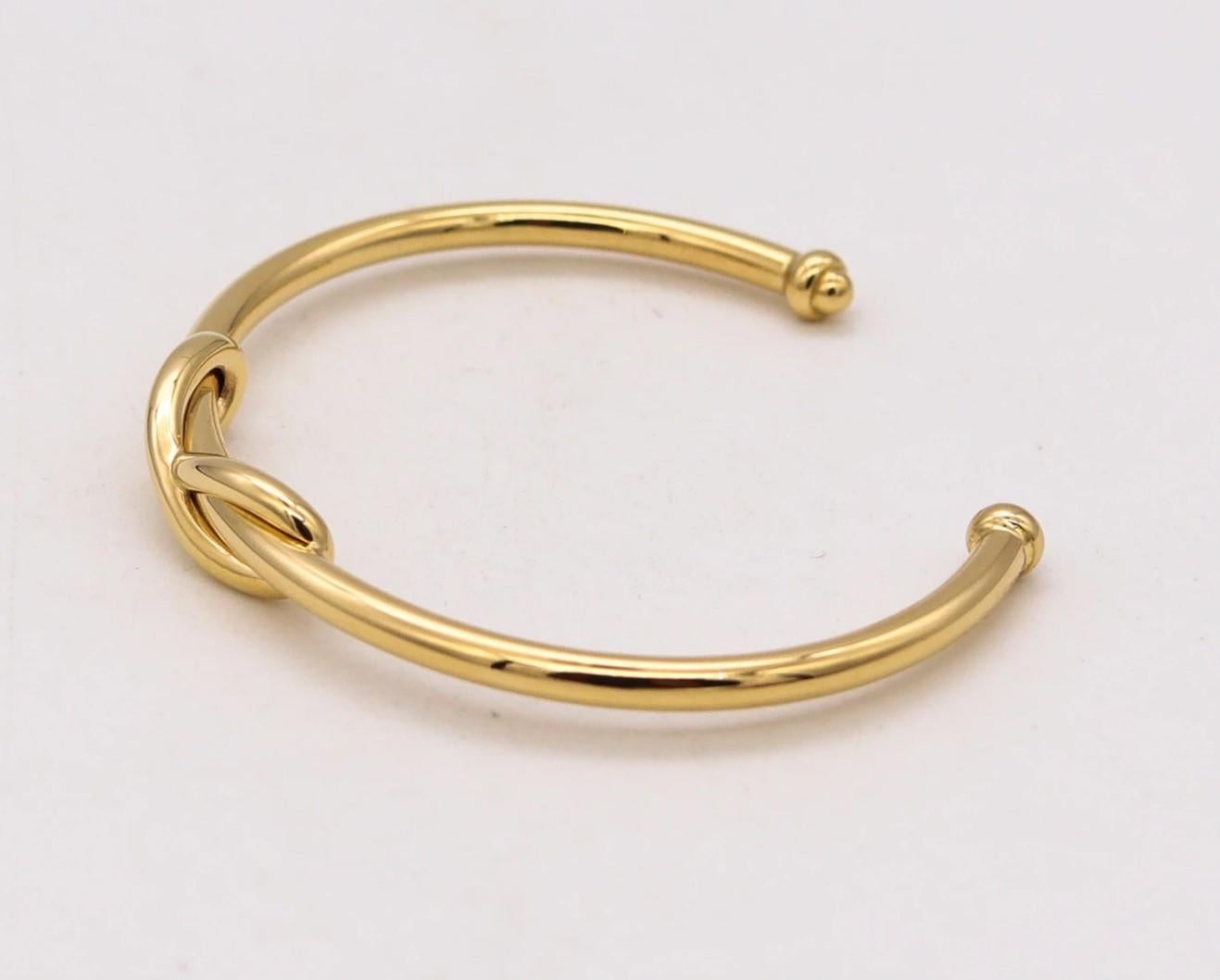 Infinity cuff bracelet designed by Tiffany & Co.

A popular piece, created by Tiffany in solid yellow gold of 18 karats, with high polished finish. The design depicts the infinity motif.

Has a total weight of 17.3 Grams and fit a wrist up to 6.25