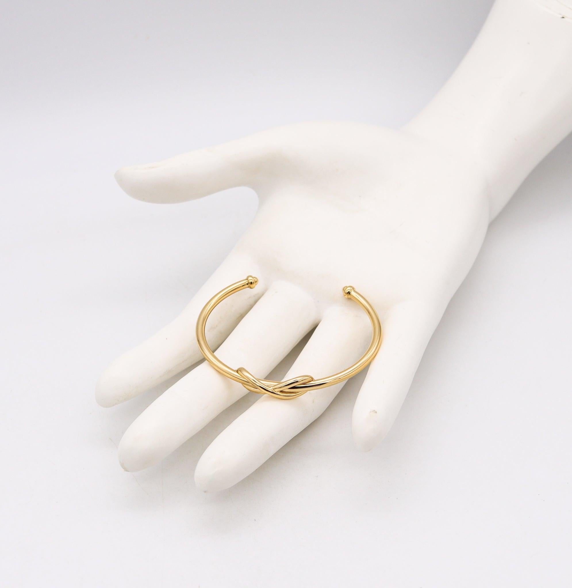 TIFFANY & CO. Manschettenarmband mit Unendlichkeitsmotiv aus massivem 18 Karat Gelbgold mit Schachteln Damen
