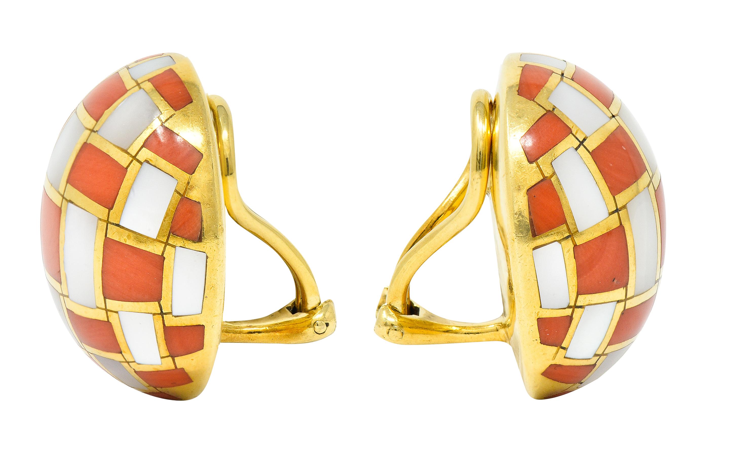 Ear-clips are designed as gold dome forms. With an inlaid gridwork of coral alternating with mother-of-pearl. Coral is opaque orange in color with mild color banding. Mother-of-pearl is white with moderate iridescence and some ringed growth.
