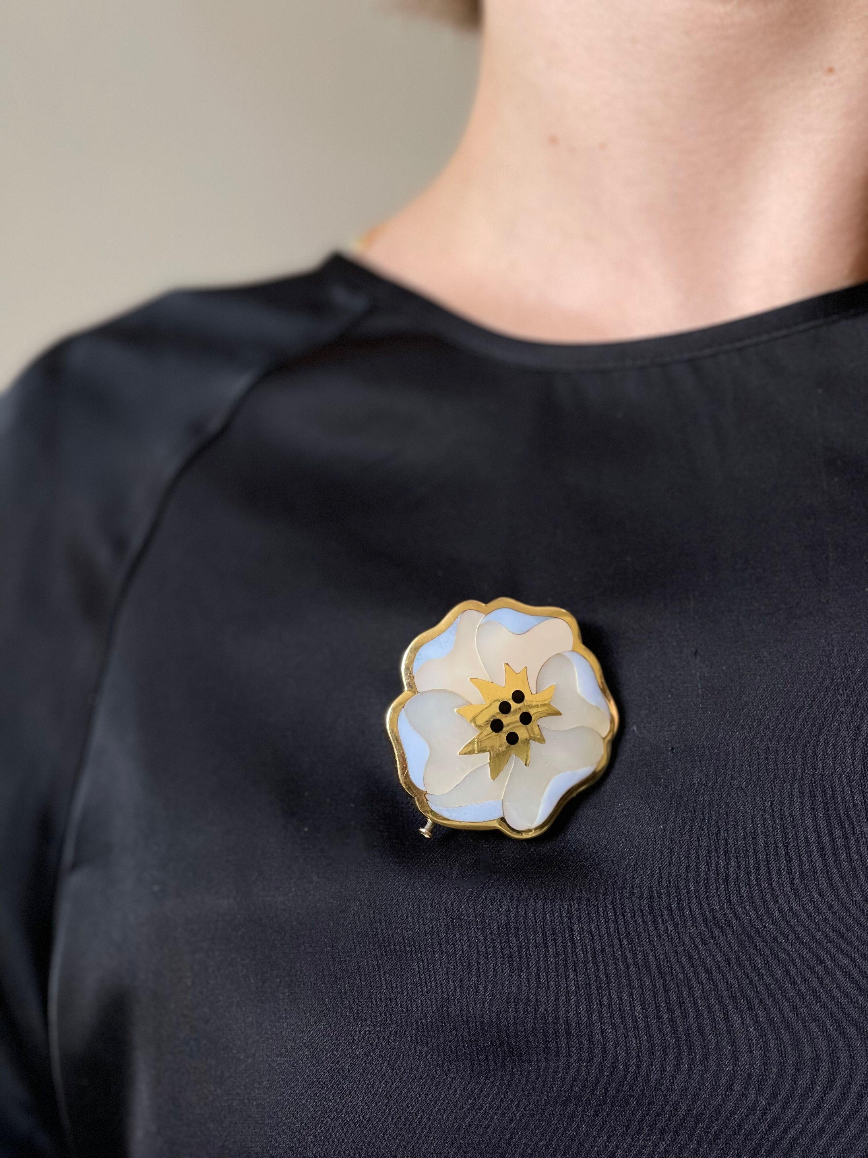 Large 18k gold flower brooch by Tiffany & Co, with onyx and mother of pearl inlay. Brooch measures 1.75