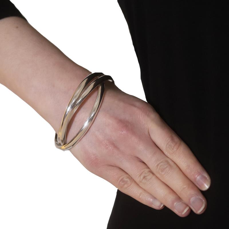 Brand: Tiffany & Co.

Metal Content: Sterling Silver

Style: Intertwined Triple Bangle

Measurements

Inner Circumference: 7 3/4