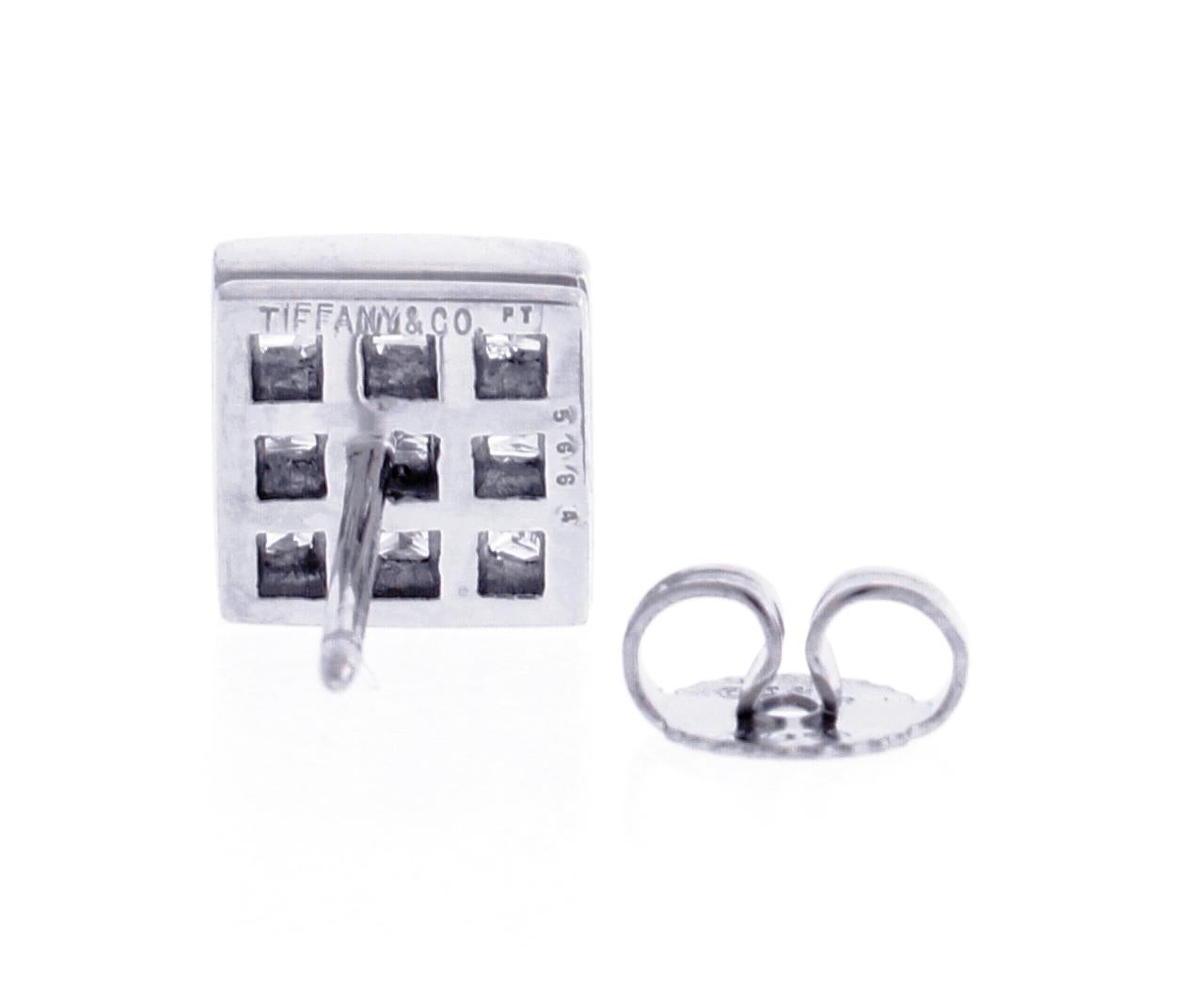From Tiffany & Co. a pair of square invisible set diamond earrings
♦ Designer: Tiffany & Co.
♦ Metal: Platinum
♦ 18 Princess cut diamonds=1.40 carats, F-G VS
♦ 8.5mm square
♦ Circa 2000
♦ Packaging: Tiffany Boxes
♦ Condition: Very good , pre-owned
♦