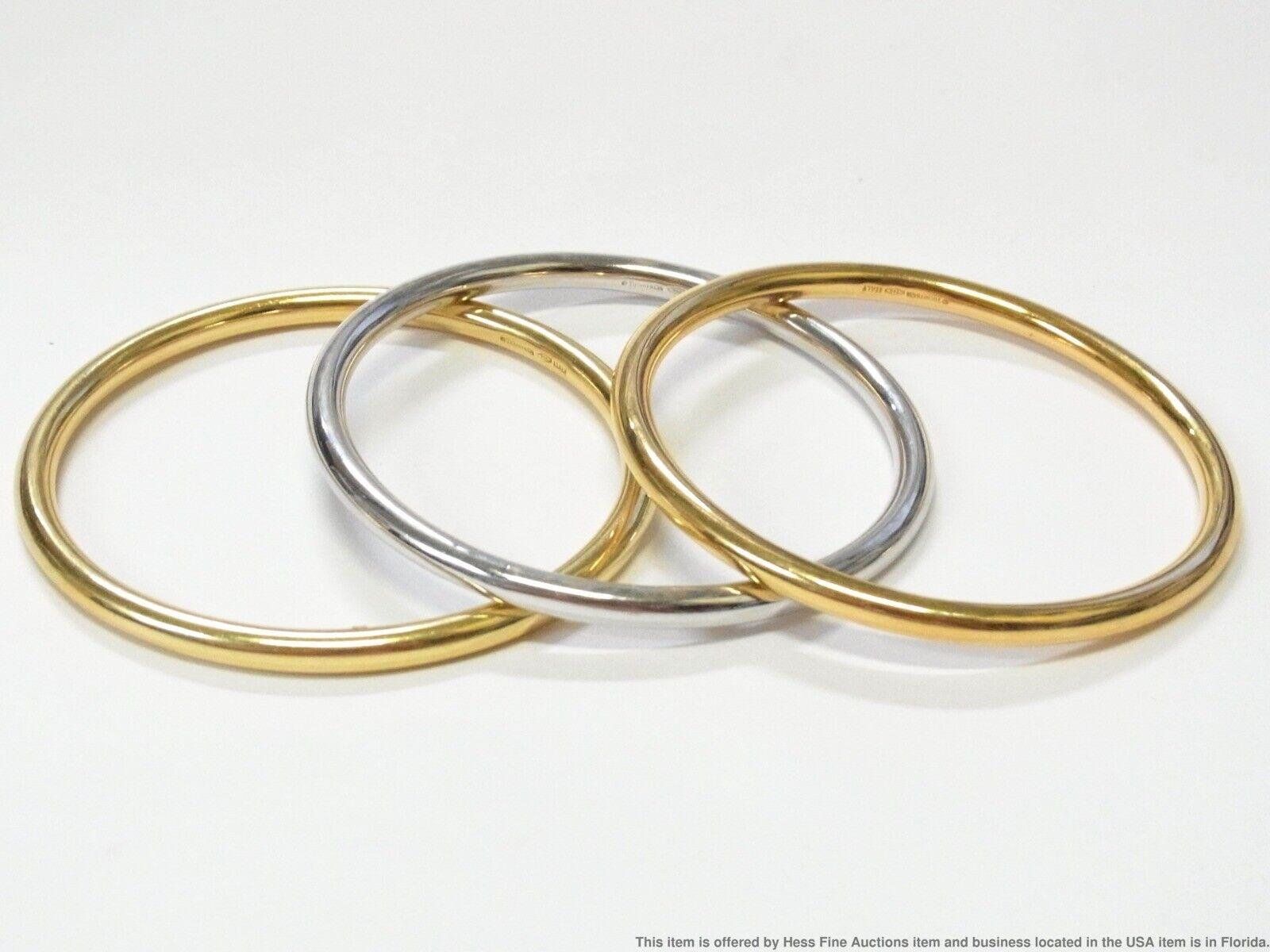 Tiffany & Co. Italy 18k Yellow & White Gold Trio of Bangle Bracelets Vintage

Here is your chance to purchase a beautiful and highly collectible designer set of bangle bracelets.  Truly a great piece at a great price! 

Description: A trio of