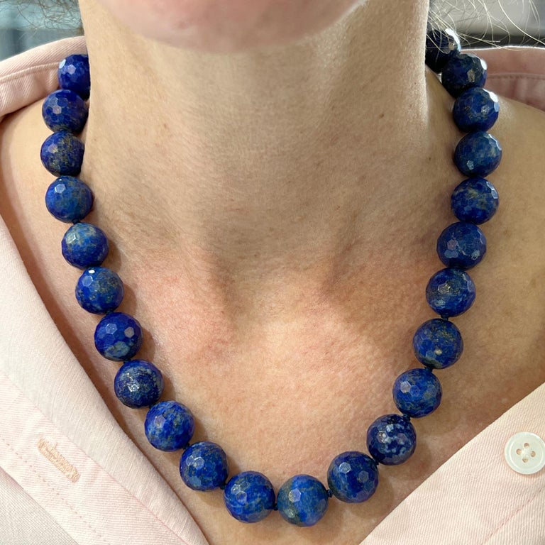 Beautifully matched lapis bead necklace by Tiffany & Co. Italy. The necklace features faceted lapis lazuli beads measuring 23.5-24.0mm, and measuring 18 inches in length. The necklace features a 14K yellow gold clasp signed T&Co. Italy 585. 