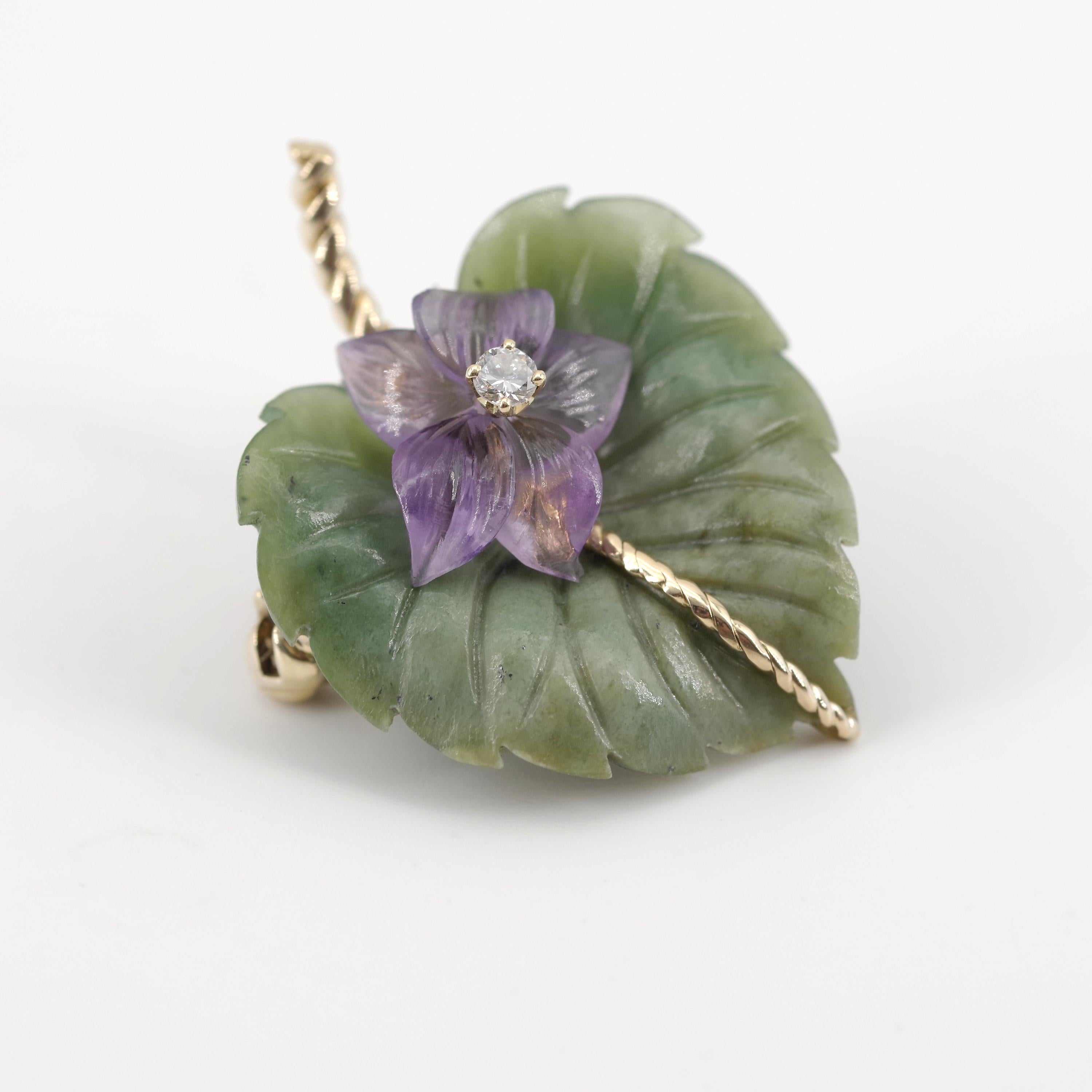 This mid-century Tiffany & Co. brooch was created in Austria circa 1955 from very fine quality nephrite jade, hand-carved into a delicate and realistic leaf. The central stem of the leaf is 18k yellow gold twisted wire. A hand-carved amethyst flower