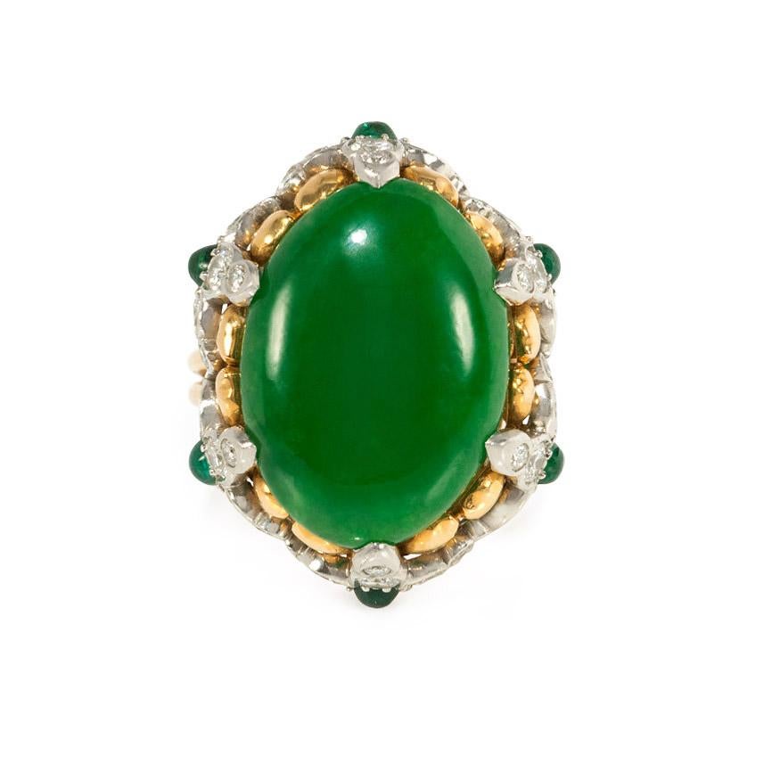 A cabochon jade cocktail ring in a floral gold, emerald, and diamond setting, in 18k and platinum.  Tiffany & Co.  Jadeite approx. 10.12 cts.; atw. 1.50 ct. diamonds

Dimensions of top: top: 1