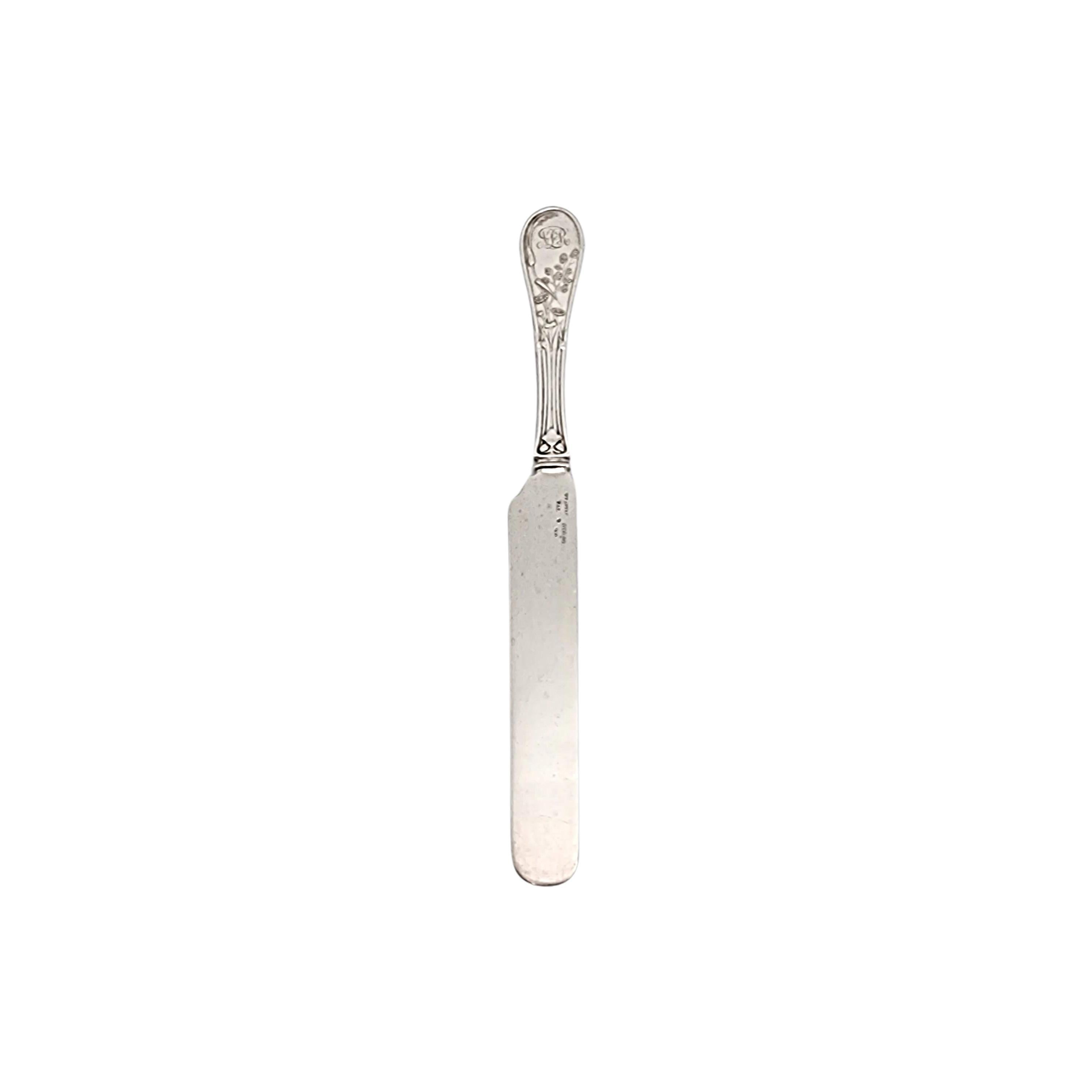 Sterling silver solid dessert knife by Tiffany & Co in the Japanese pattern with monogram.

Monogram appears to be NLeR

Designed by Edward C. Moore in 1871, the Japanese pattern was inspired by Japanese bird paintings of the 19th century. This