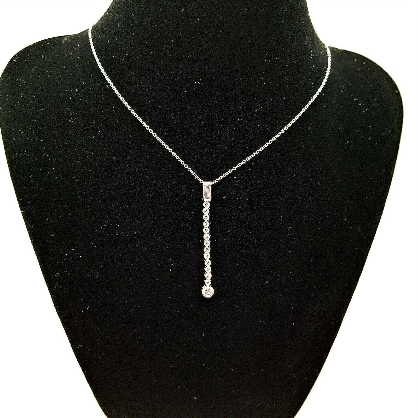  Bring the elegance with this stunning Tiffany & Co jazz drop pendant. This piece features 1 piece of Baguette cut diamond in approximately 0.11 carat and 14 pieces of round cut diamonds in approximately 0.40 carat total weight. This necklace