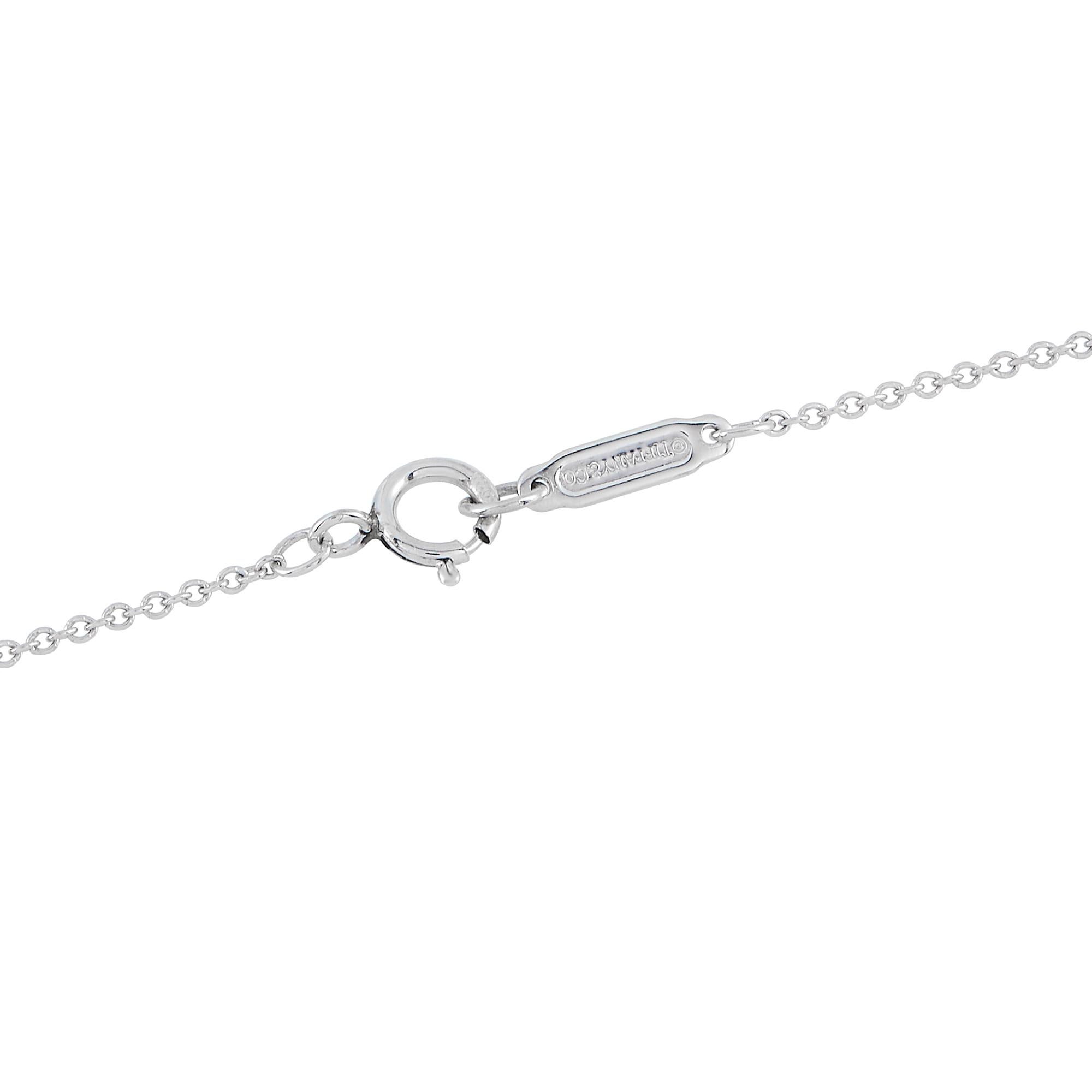 This Tiffany & Co. Jazz necklace is simply stunning. Ideal for even your most special occasions, the Platinum pendant measures 1.0 long by 0.15 wide and is suspended from a 17 chain. Diamonds with a total weight of 0.30 carats allow it to catch the