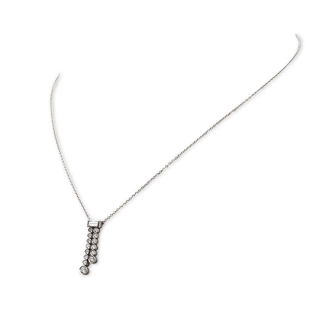 Authentic Tiffany & Co. Jazz necklace crafted in platinum features a diamond drop pendant comprised of two strands of round brilliant cut diamonds hanging from a centered baguette cut diamond. The estimated total carat weight is .50. Signed Tiffany