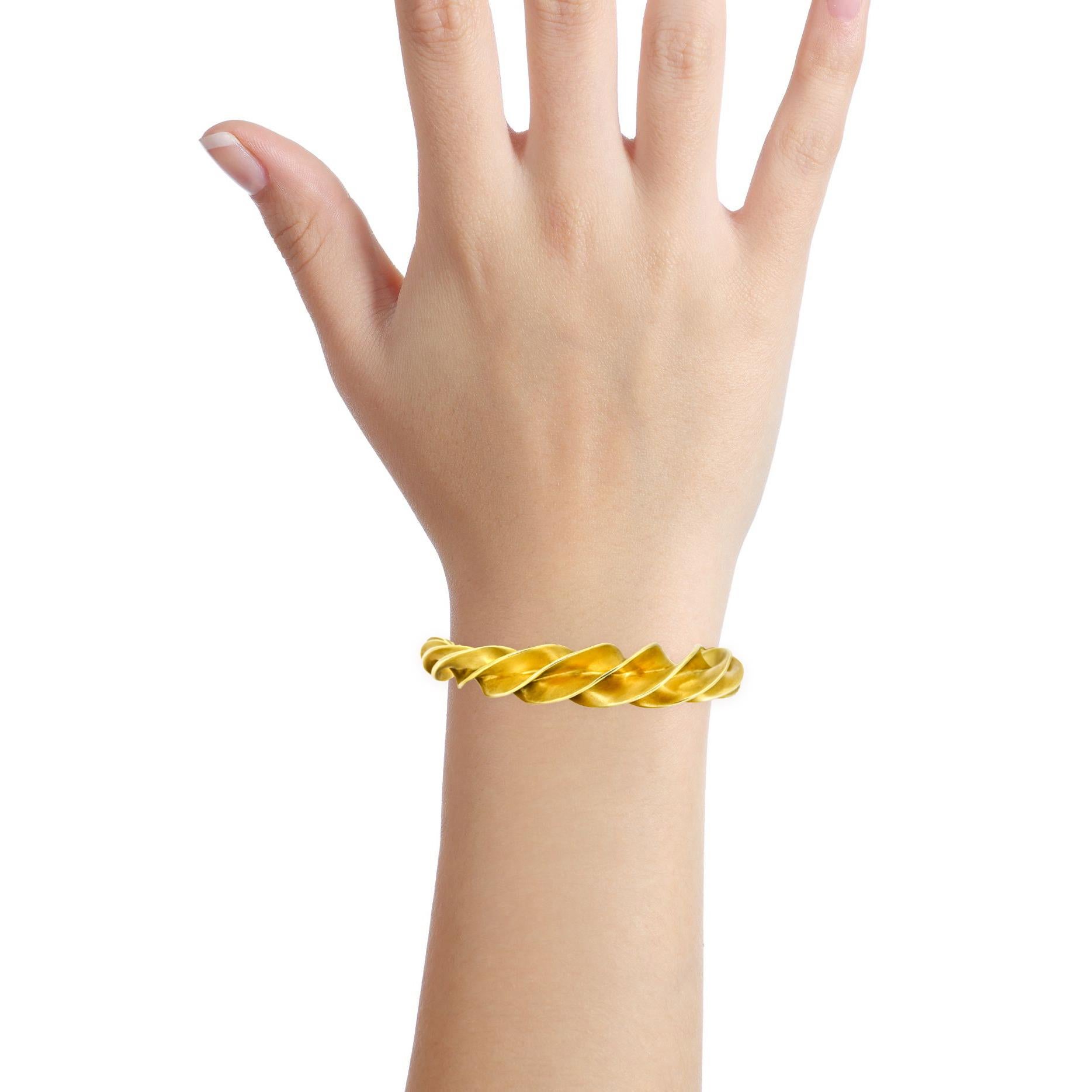Tiffany & Co. Schlumberger crazy twist bracelet in 18-karat yellow gold. Current style. Retail $13,000. 

Size, Medium (fits a wrist up to 6 inches)
Length, 6.25 inches
Width, 14mm - 7mm
Depth, 14mm
Weight, 58.65 grams 