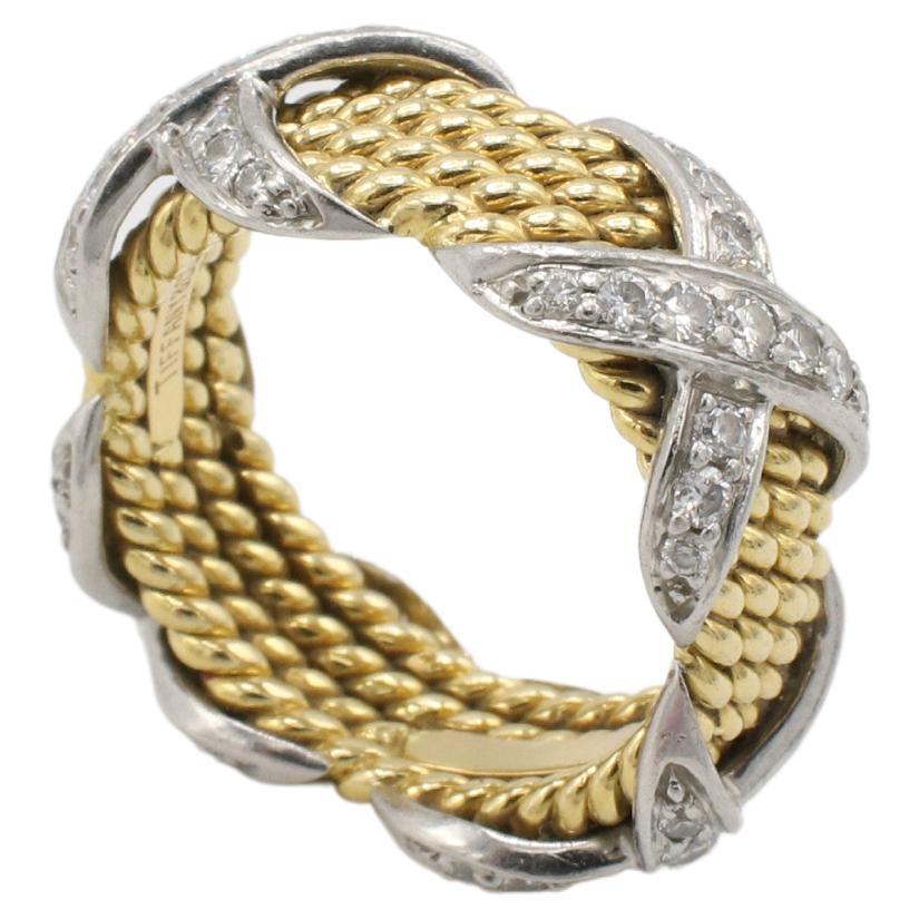 Tiffany & Co. Jean Schlumberger Four-Row Natural Diamond X Band Ring
Metal: 18k yellow gold & platinum
Weight: 9.64 grams
Size: 5 (US)
Width: 8mm
Signed: Tiffany & Co. Schlumberger 750
Diamonds: Approx. .60 CTW F-G VS round natural diamonds
