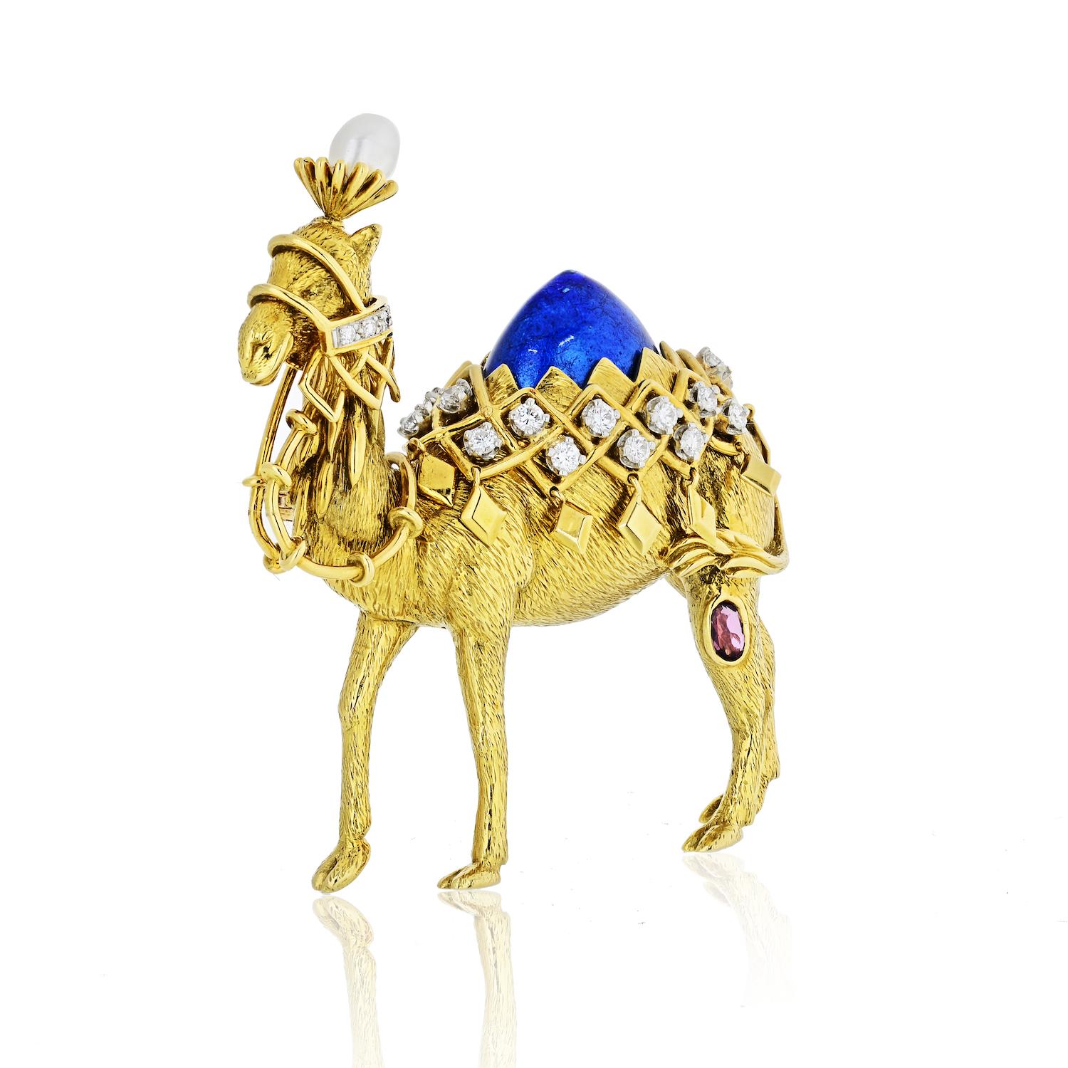 Designed by Jean Schlumberger for Tiffany & Co., this marvelous piece compels with its exquisite craftsmanship quality and lavish decor. The brooch depicts a camel and it is made of luxurious 18K yellow gold, embellished with ruby, pearl, and