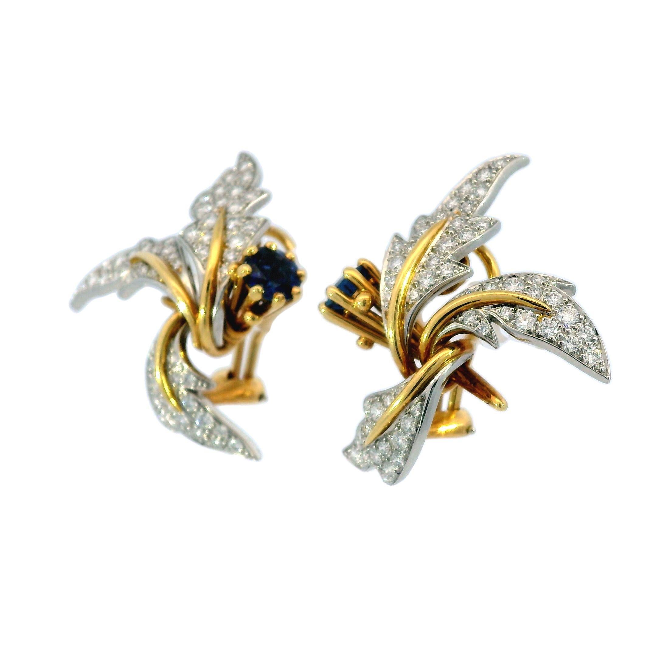 These stunning Tiffany & Co. Jean Schlumberger Platinum Gold Diamond Sapphire Floral Earrings are a true masterpiece. Featuring 2.24 carats of top-quality diamonds and 1.74 carats of rich blue sapphires, these earrings showcase the exquisite