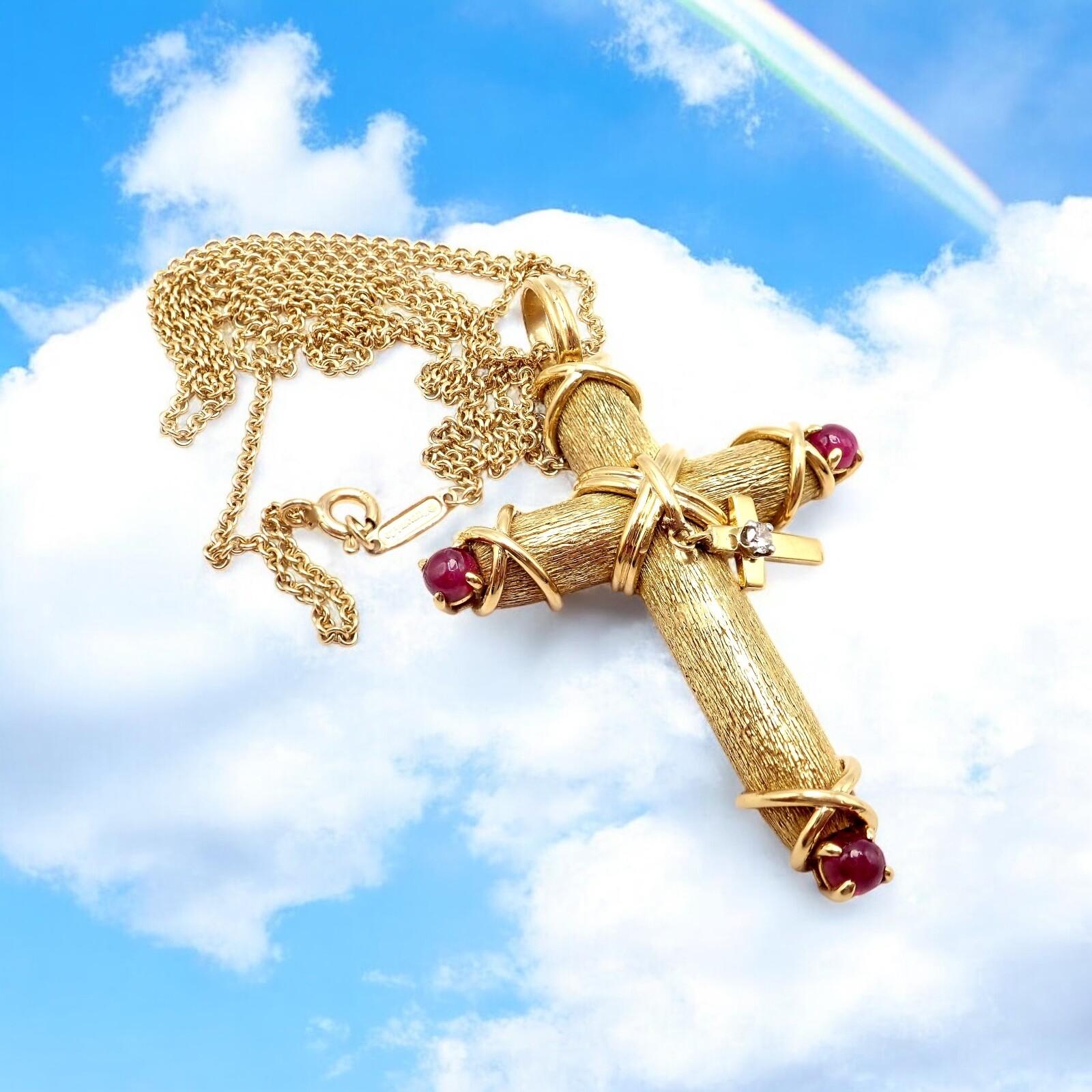 18k Yellow Gold Ruby Diamond Cross Pendant Necklace by Jean Schlumberger for Tiffany & Co. 
This Tiffany & Co. Schlumberger necklace features a striking cross pendant crafted in 18k yellow gold with a textured finish. 
Accented by vibrant ruby