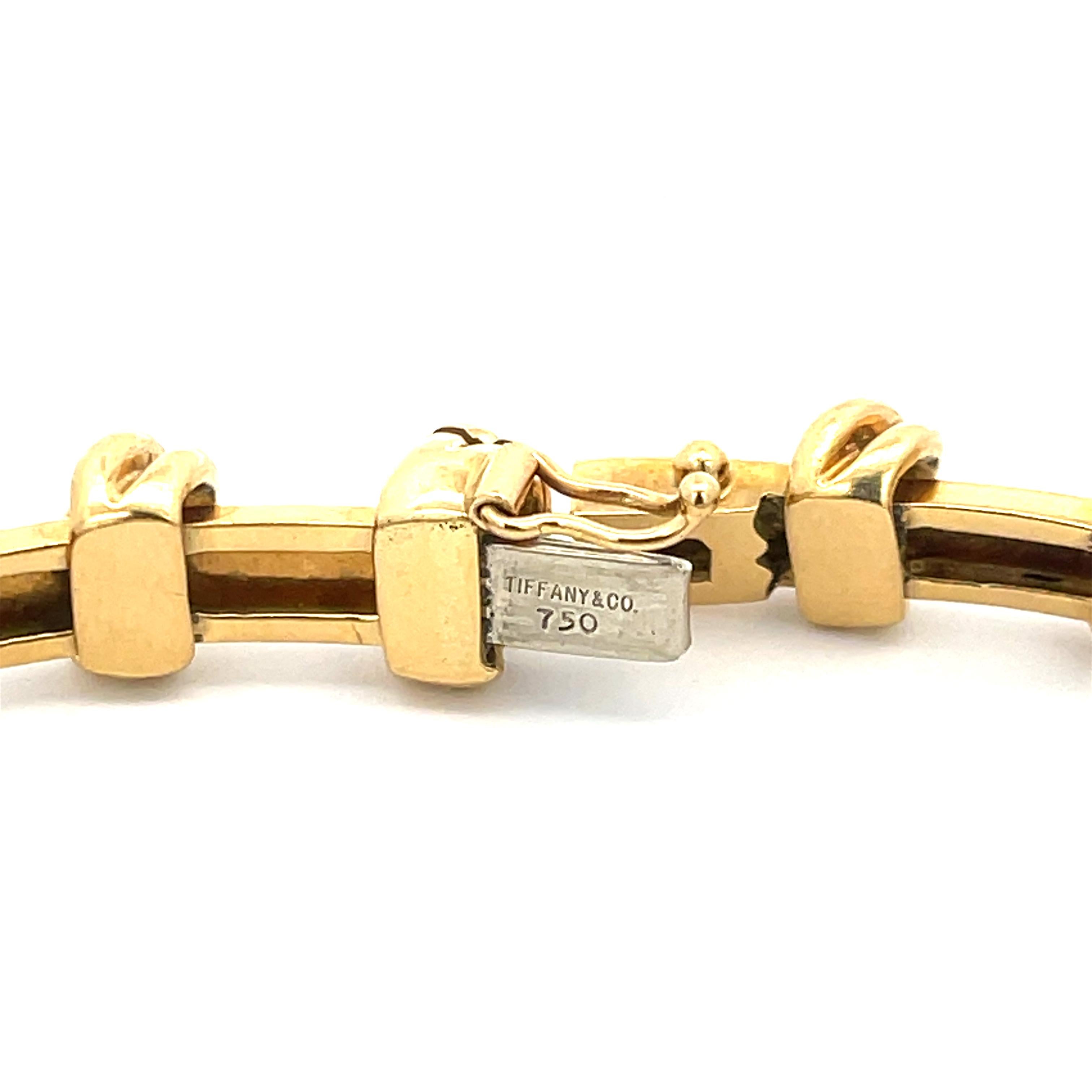 Tiffany & Co. Knot Bracelet in 18K Yellow Gold. The bracelet is 7.5 inches long, 8mm wide, and weighs 37.5 grams. Stamped Tiffany & Co. 750