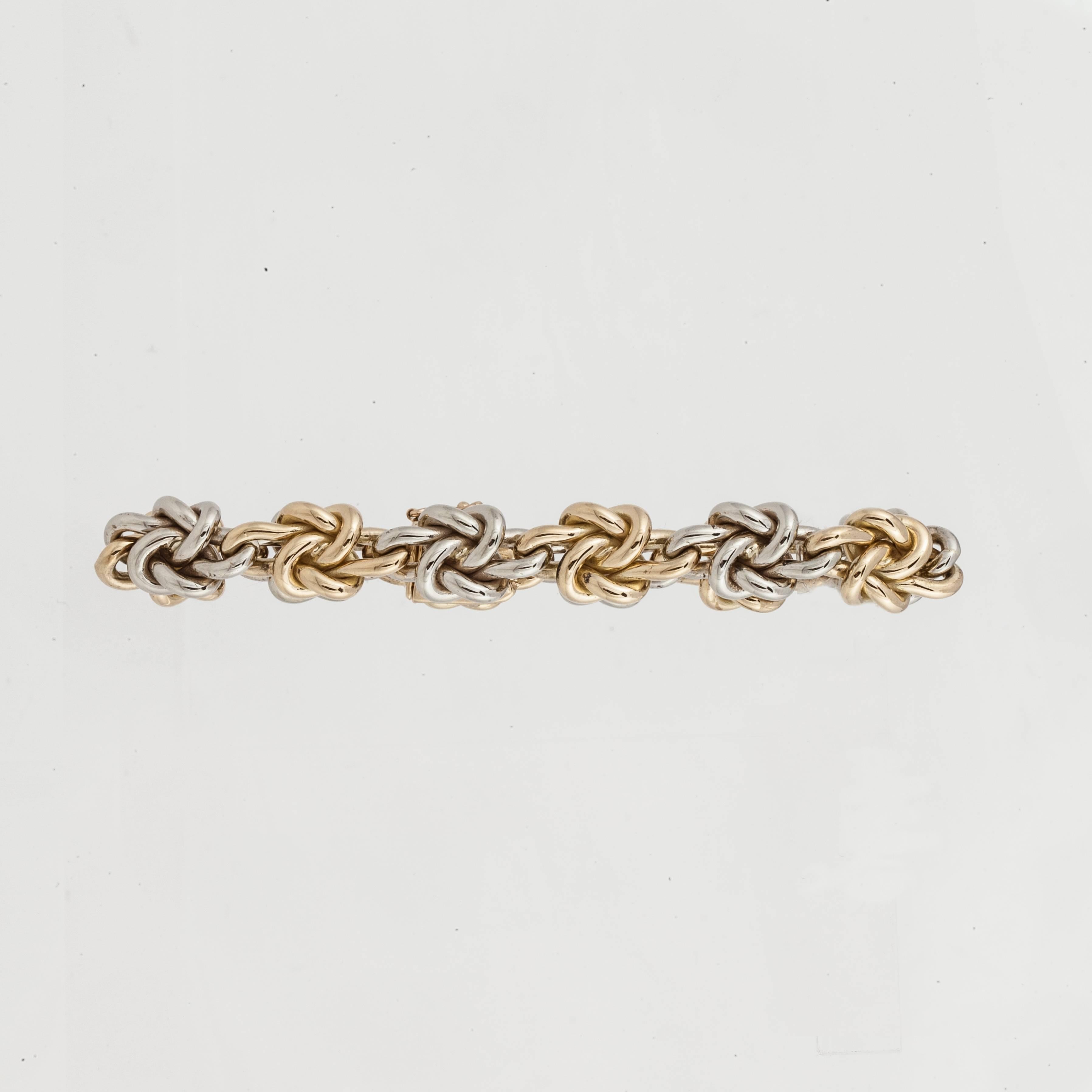 Tiffany & Co. bracelet with knots in alternating 18K white and yellow gold.  Measures 7 1/2 inches long and 7/16