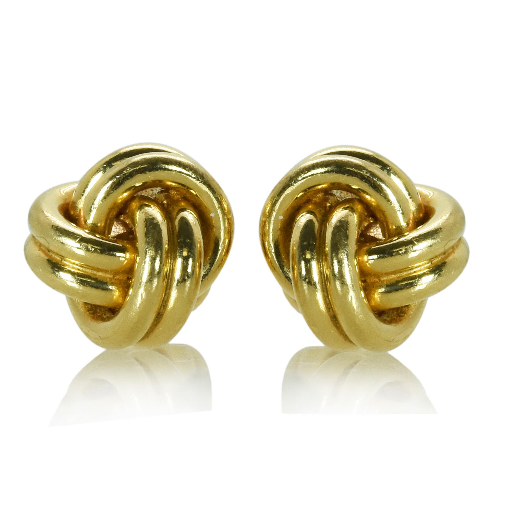 A pair of yellow gold cufflinks by Tiffany & Co. The cufflinks are in a knot motif and made in 14k yellow gold. They are signed by Tiffany & Co. 
